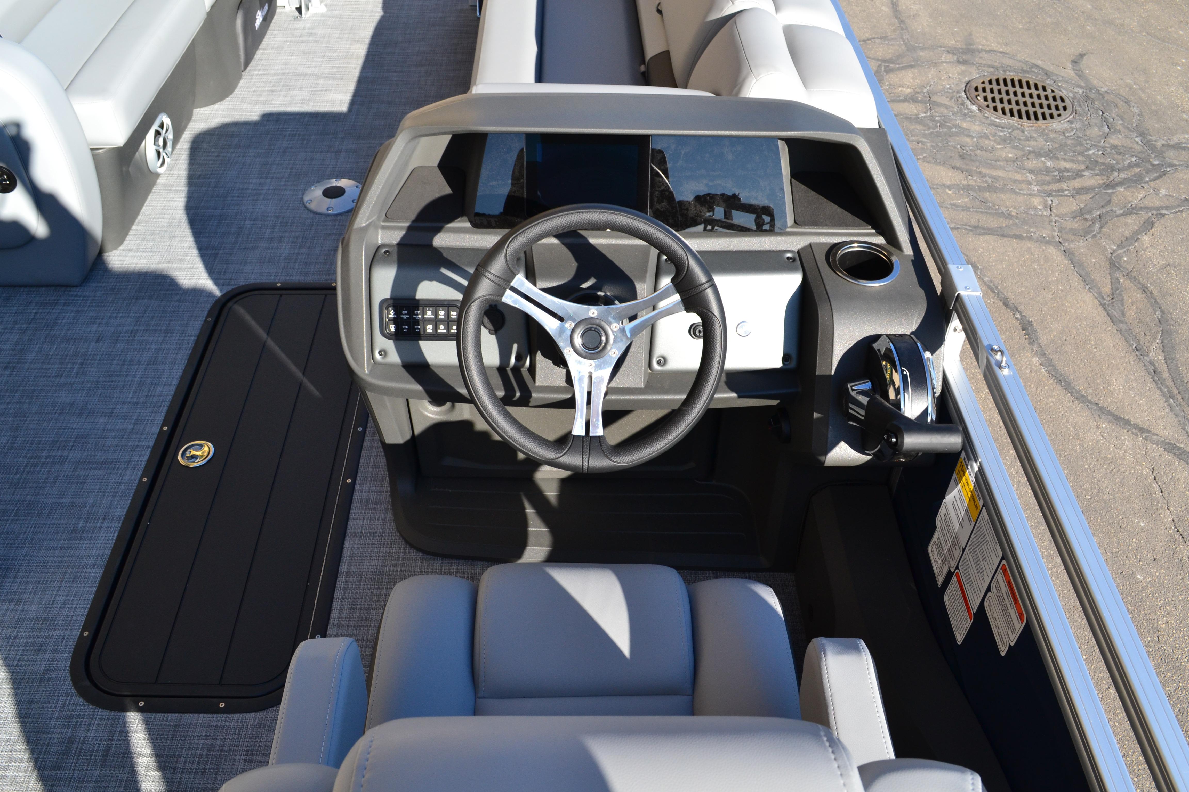 2026 Sun Tracker SportFish 22 XP3 boat cockpit with steering wheel and control panel.