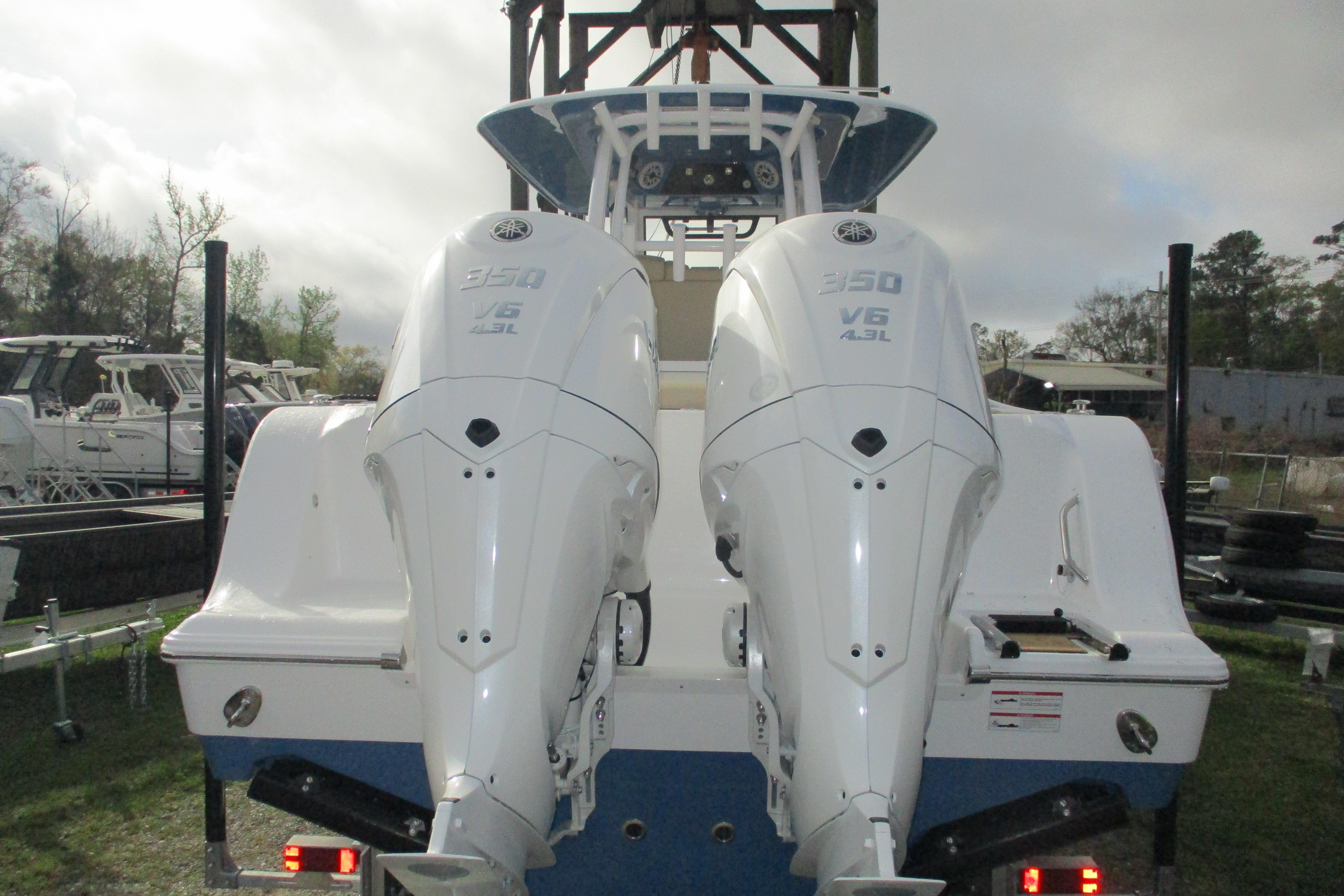 2026 Sportsman Open 302 Center Console with dual 350 V6 engines, rear view.