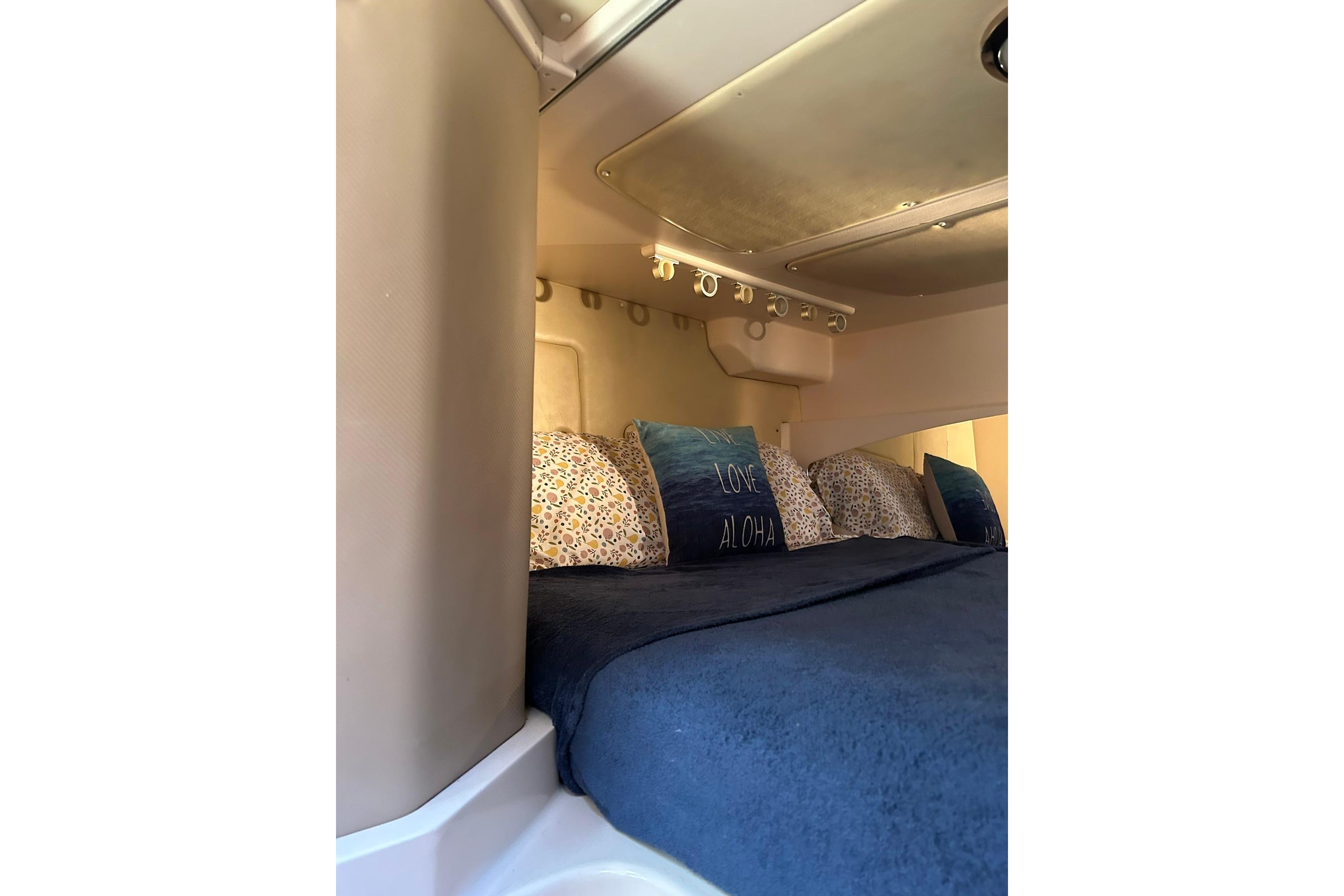 Cozy cabin interior of 2007 Grady-White Express 360 with plush bedding.