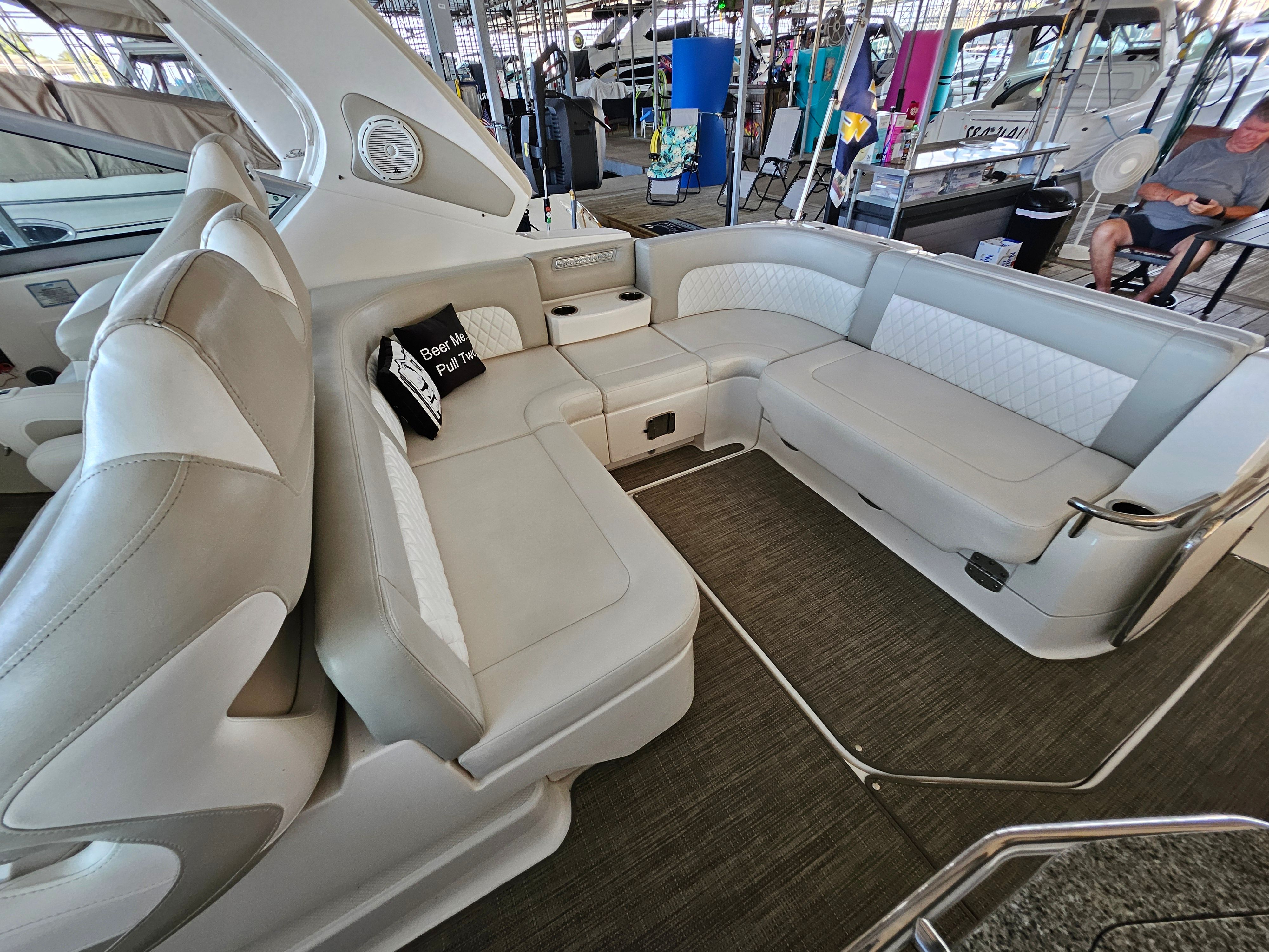 Interior of a 2014 Chaparral 330 Signature yacht with beige leather seating.