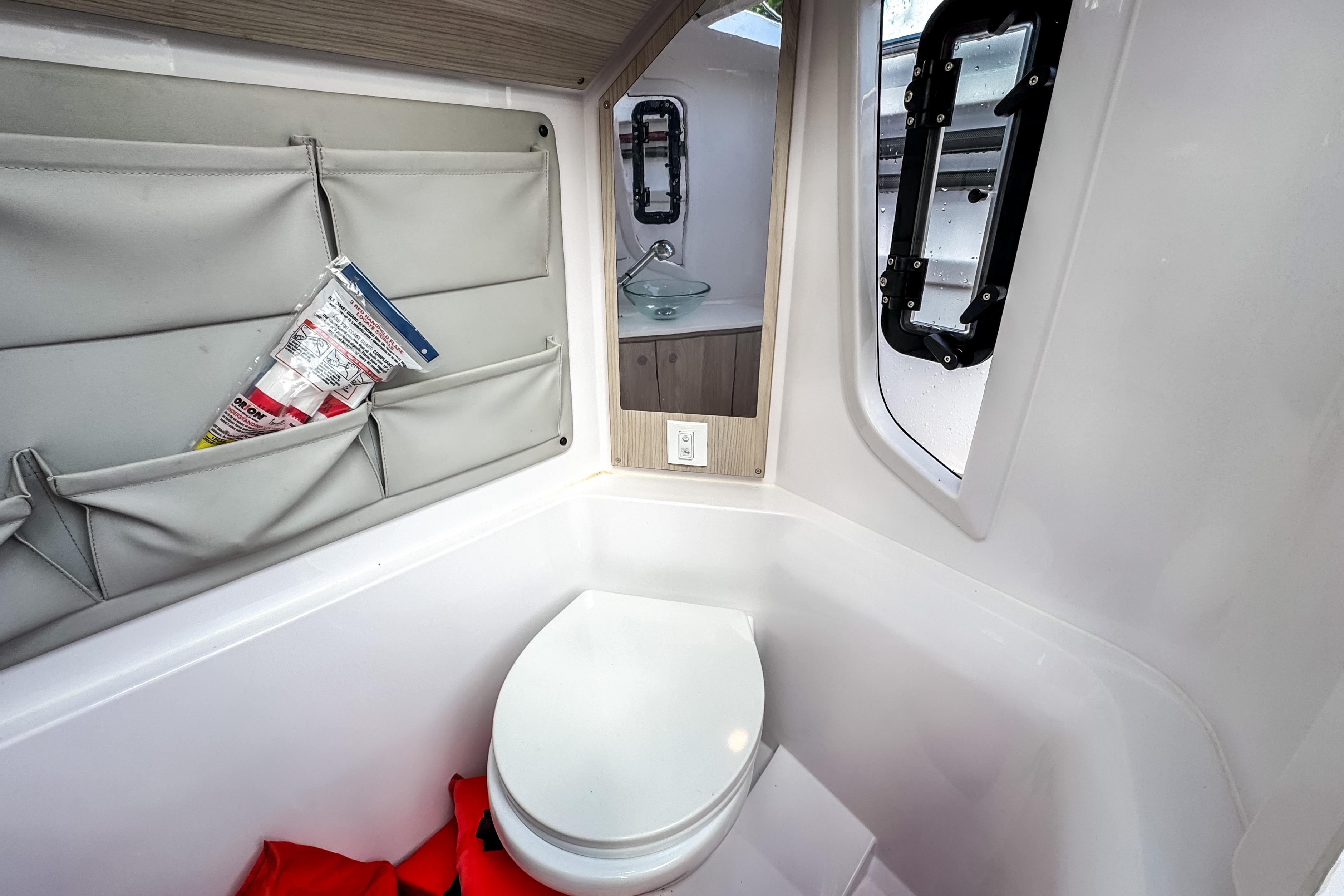 Interior of STERK 31 yacht with toilet and storage, model year 2025.