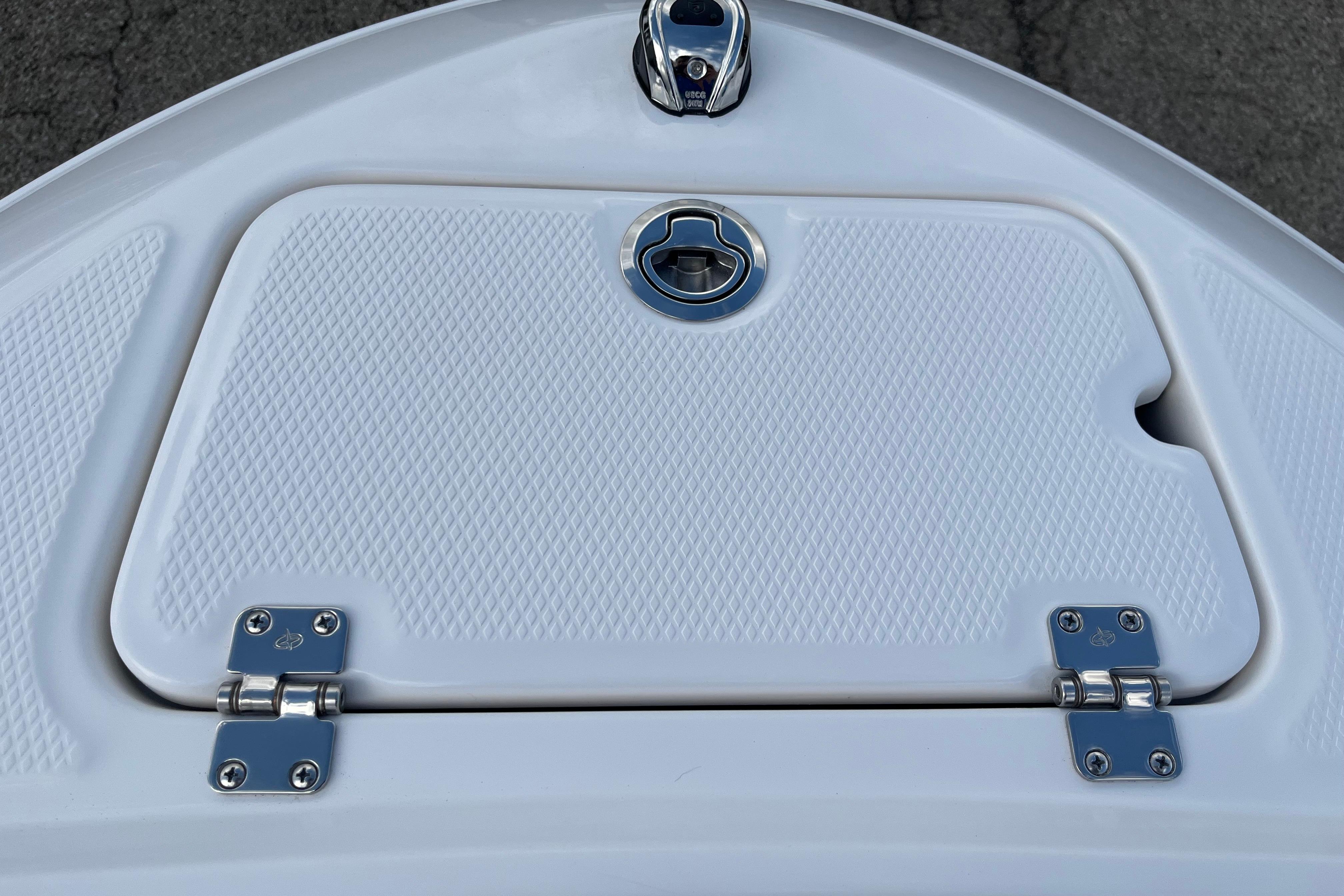 2026 Chaparral 21 SSi boat hatch with textured surface and metal hinges.