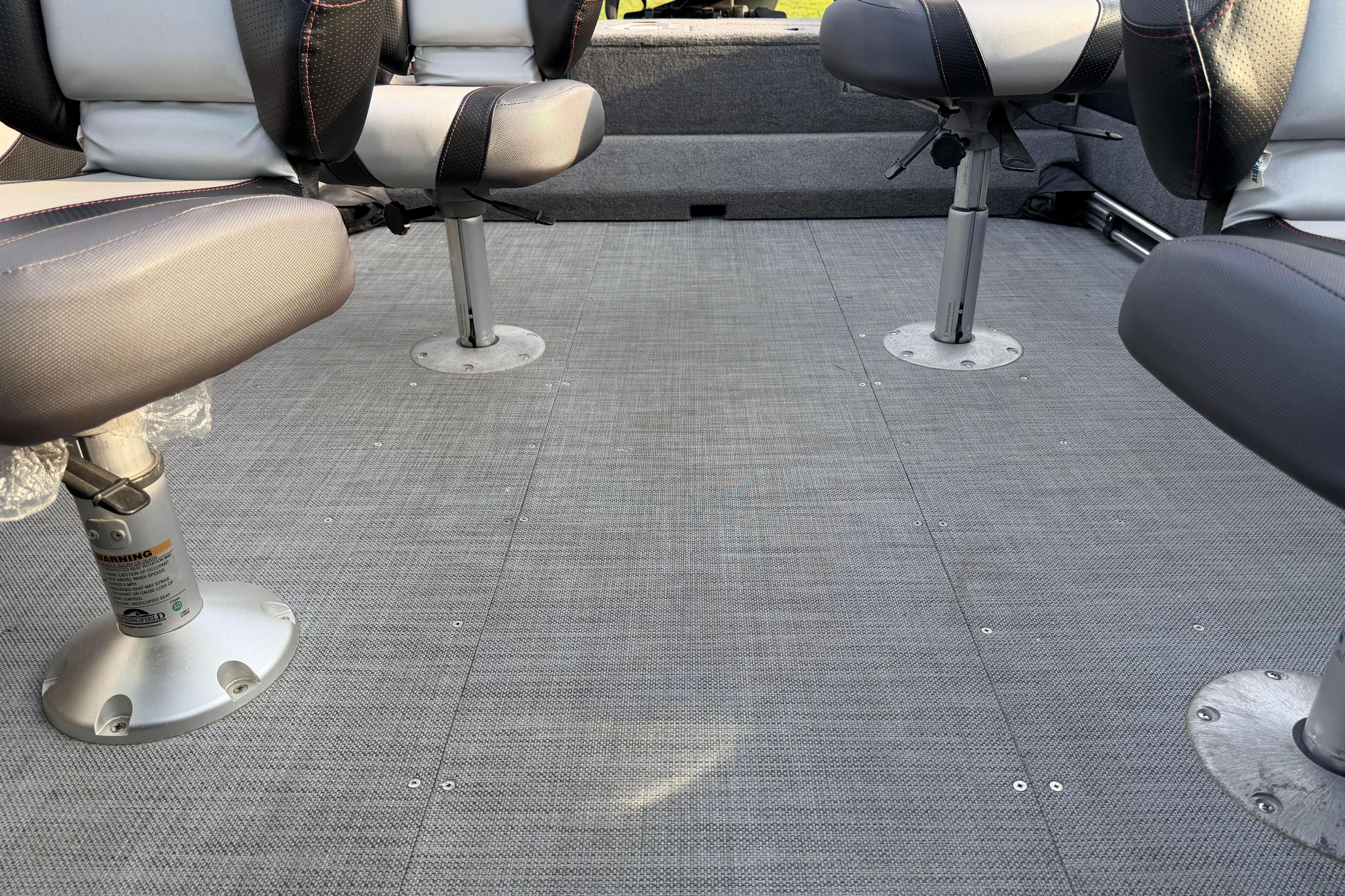 2019 Alumacraft Trophy 205 boat interior with gray flooring and swivel seats.