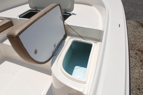 2023 Sundance DX20 boat storage compartments with open lids, showcasing interior space.