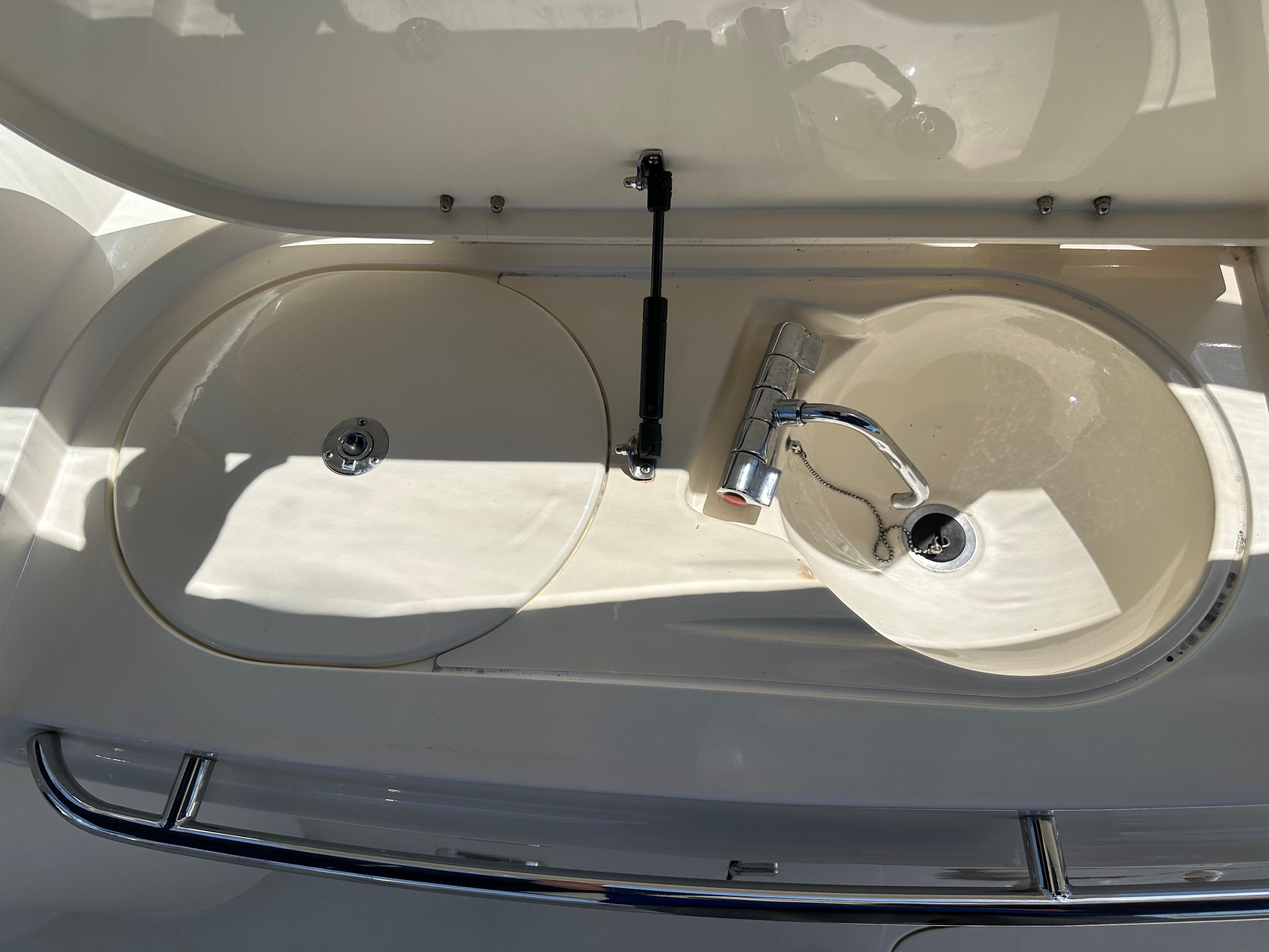 Sunseeker Camargue 47 yacht sink area, 1997 model, featuring dual basins and chrome faucet.