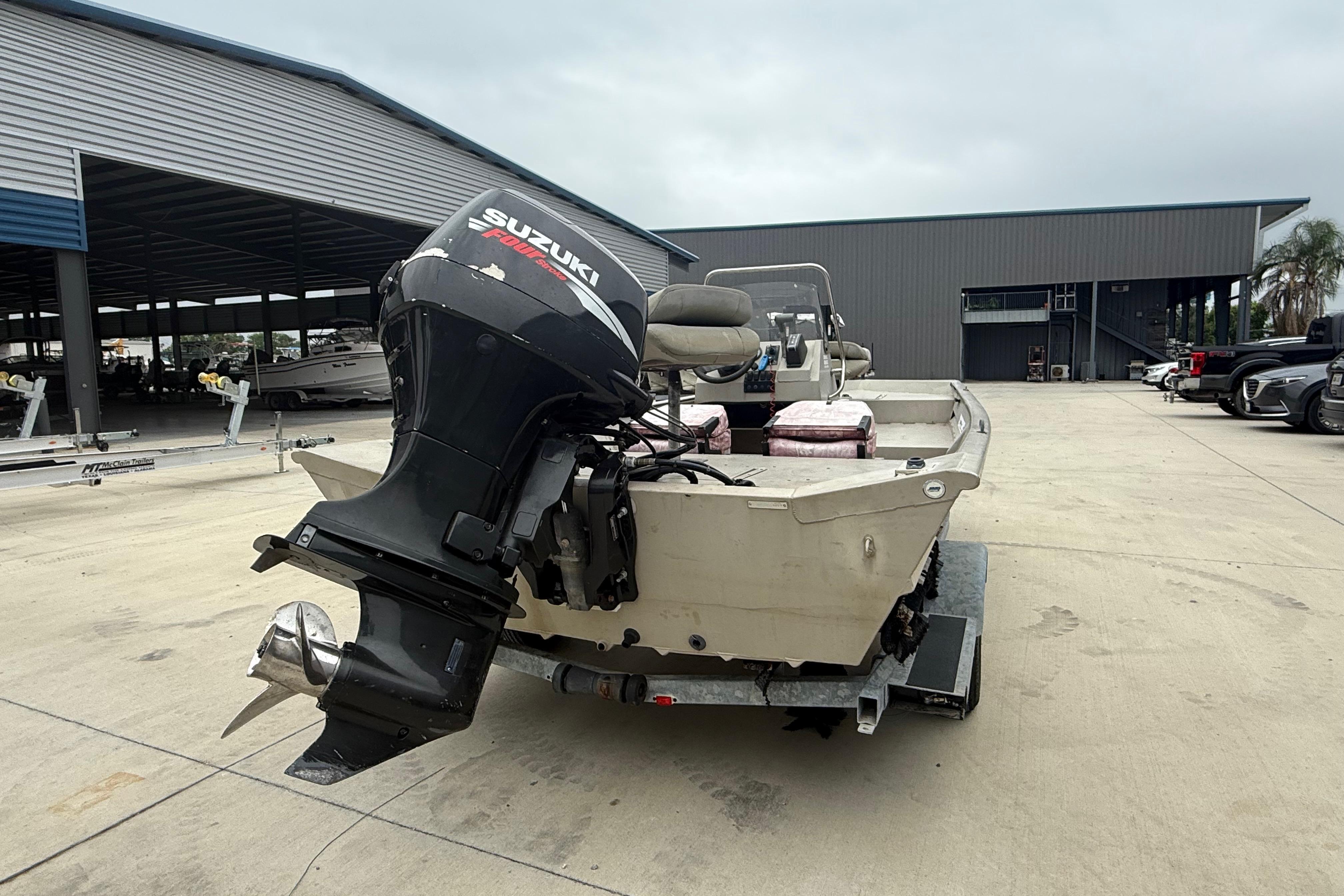 2008 SeaArk 1652 MV boat with Suzuki outboard motor in a marina setting.