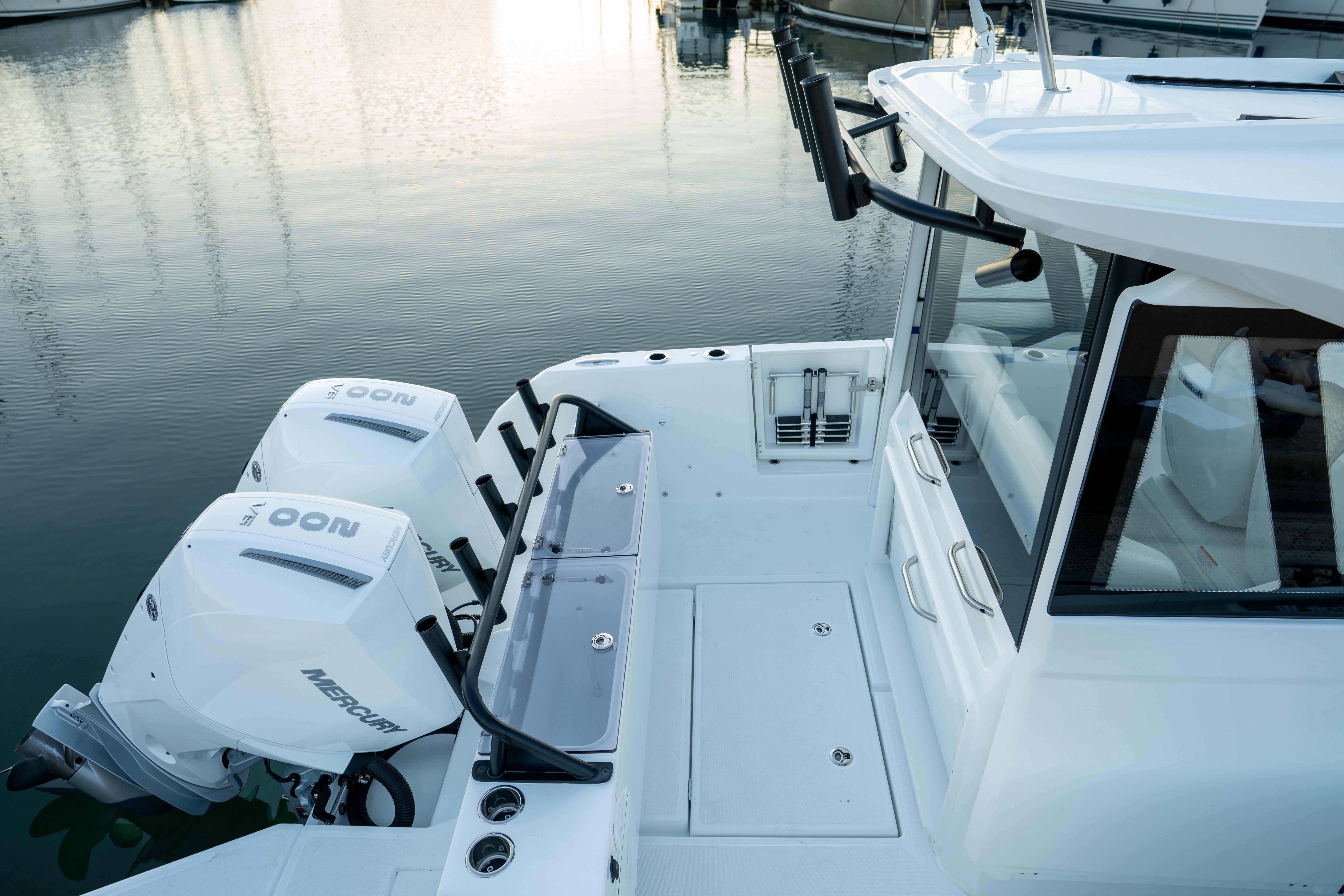 2026 Wellcraft 28 Explorer boat with dual Mercury outboard engines docked at marina.