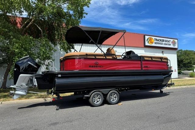 2026 Regency 230 DL pontoon boat on trailer outside Tracker Boat Service Center.