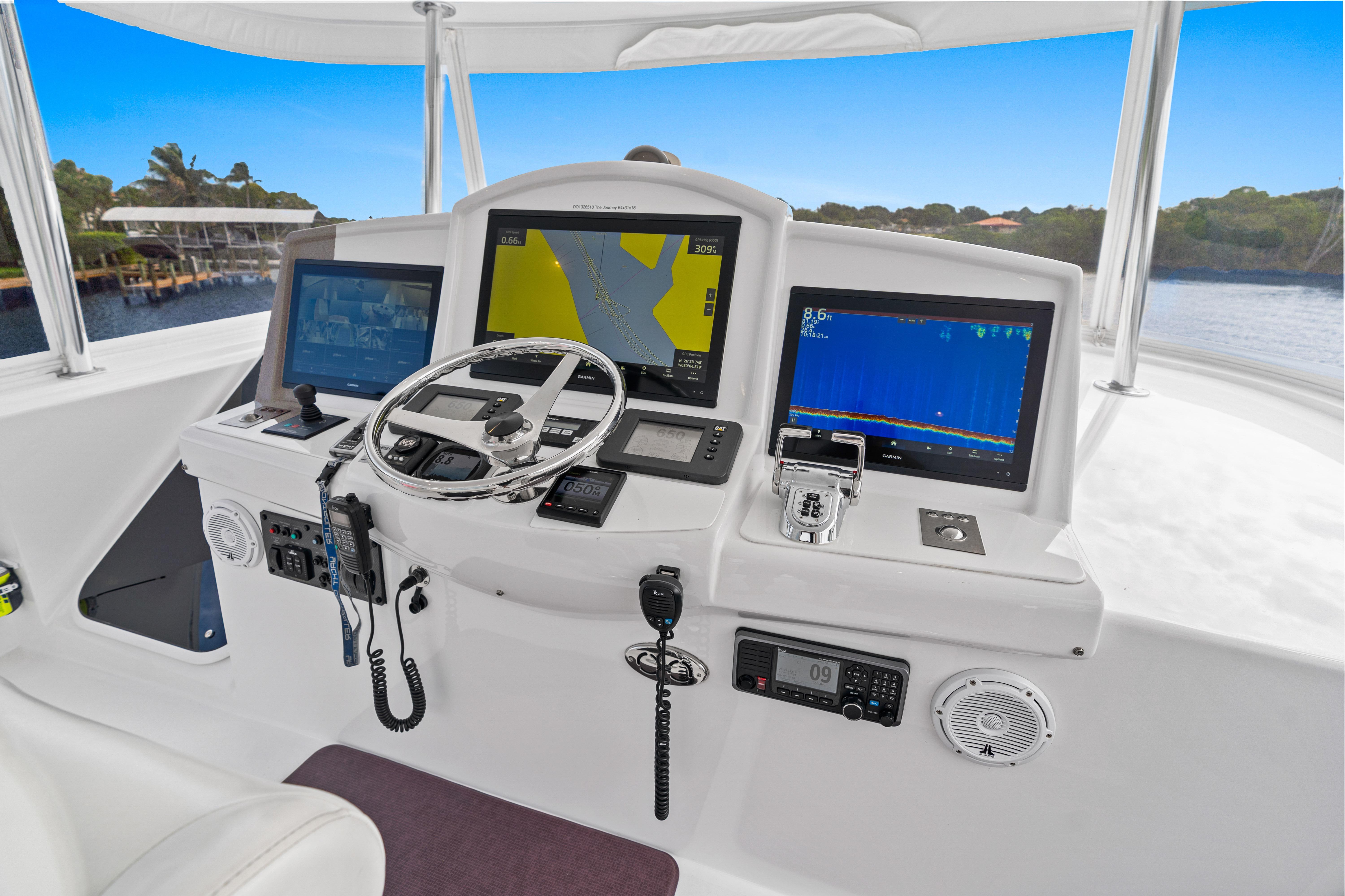 Helm of 2008 Hatteras 64 Motor Yacht with navigation screens and controls.