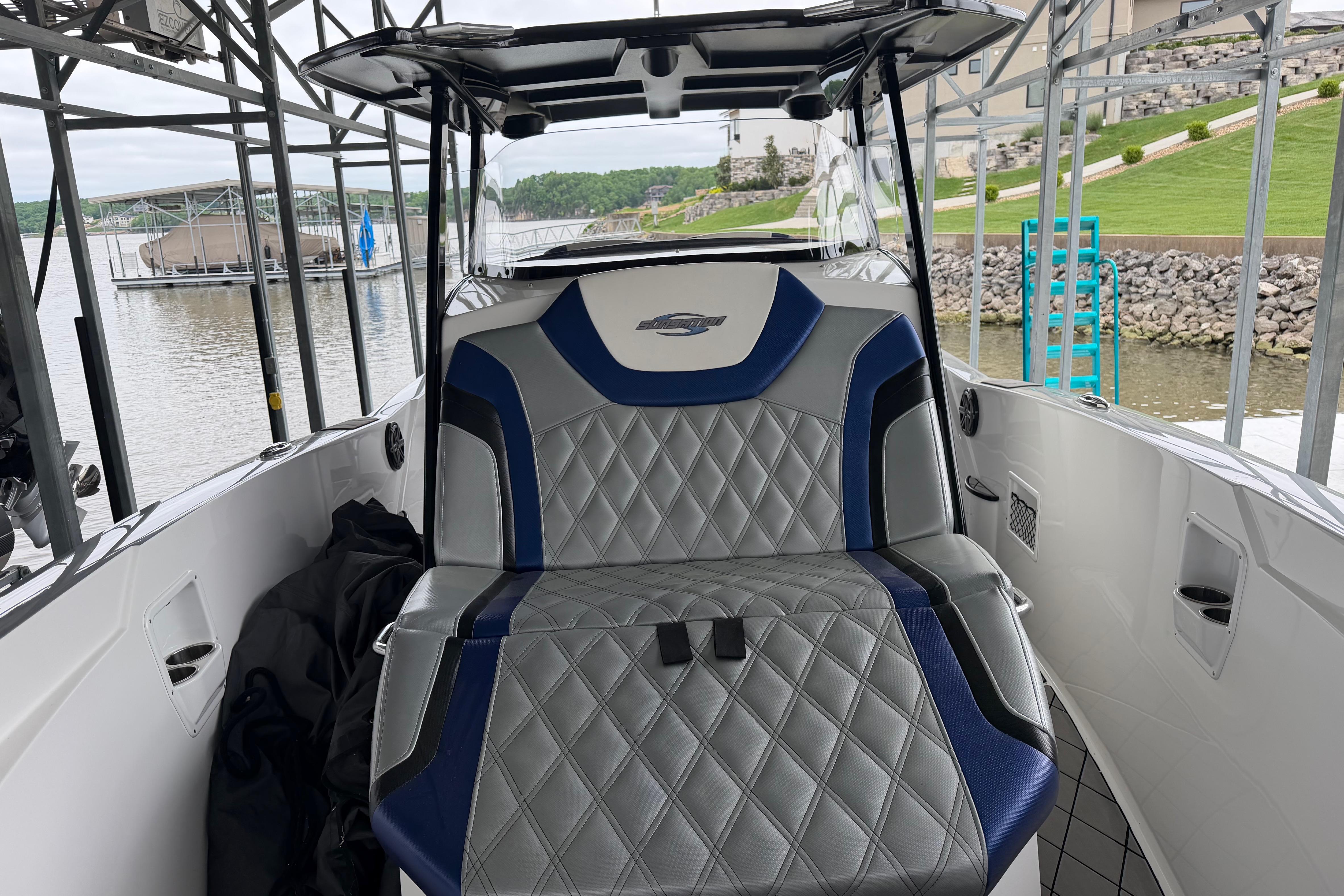2018 Sunsation 32 CCX boat interior with stylish seating at a marina.