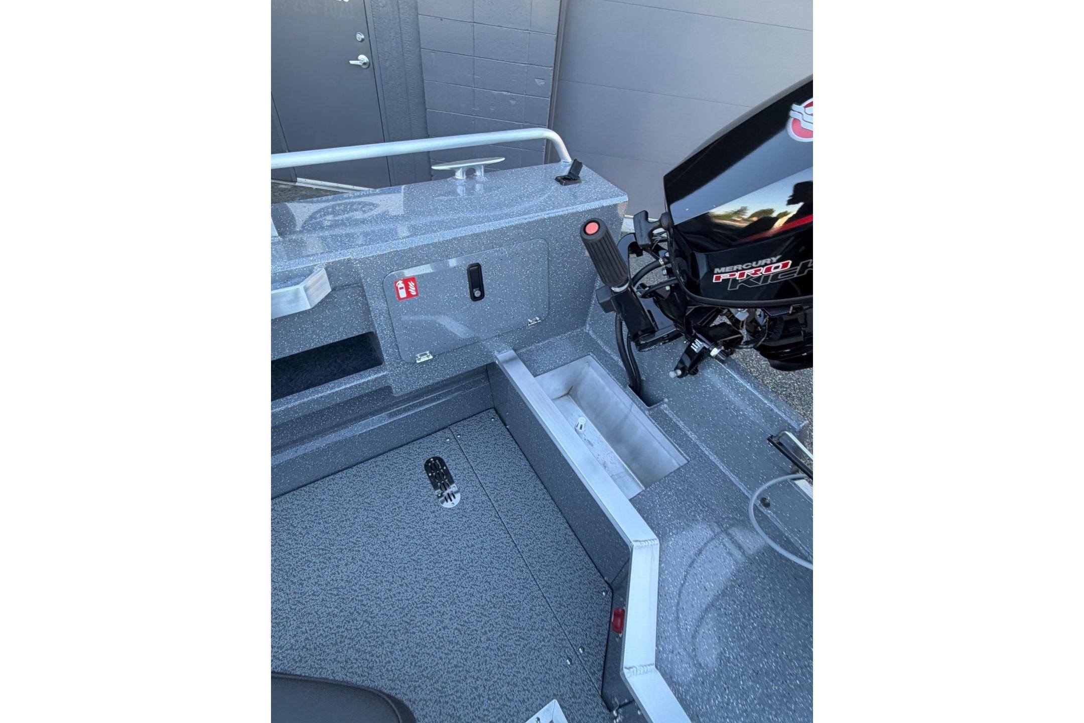 Interior view of a 2026 Thunder Jet 209 Rush OT boat, showcasing storage and motor controls.