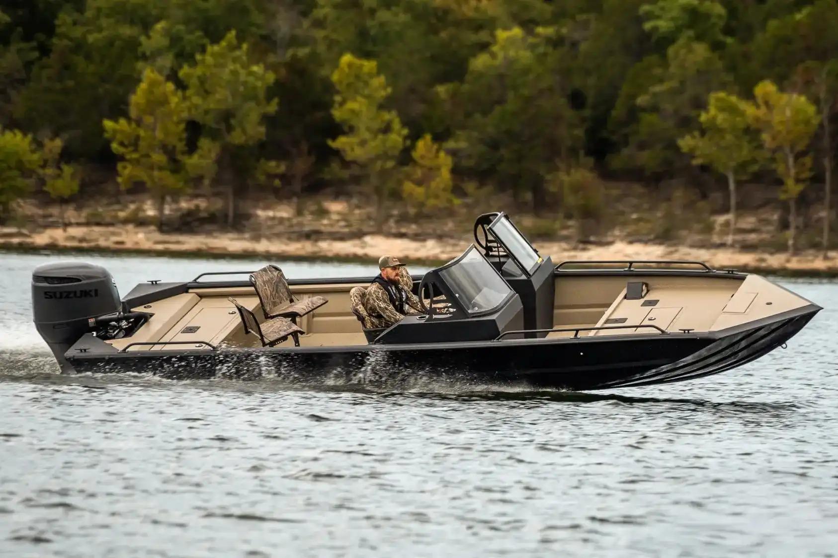 Manufacturer Provided Image: 2026 SeaArk Protege 240 boat cruising on a lake with lush green trees.