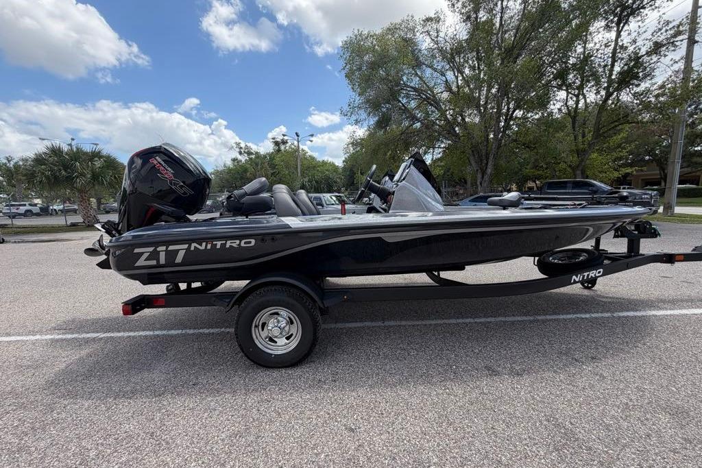 2026 Nitro Z17 boat on trailer in parking lot, under cloudy sky.