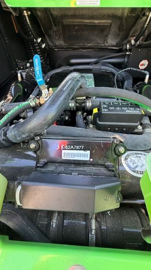 Engine compartment of a 2018 Nautique Super Air Nautique G23 with green accents.