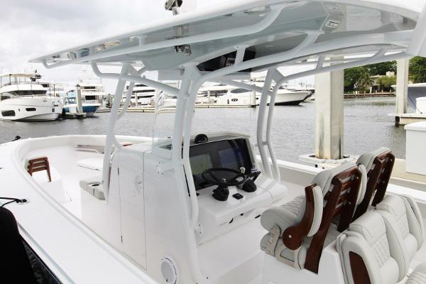 2024 Jupiter 34 HFS boat interior with helm, seating, and marina view.
