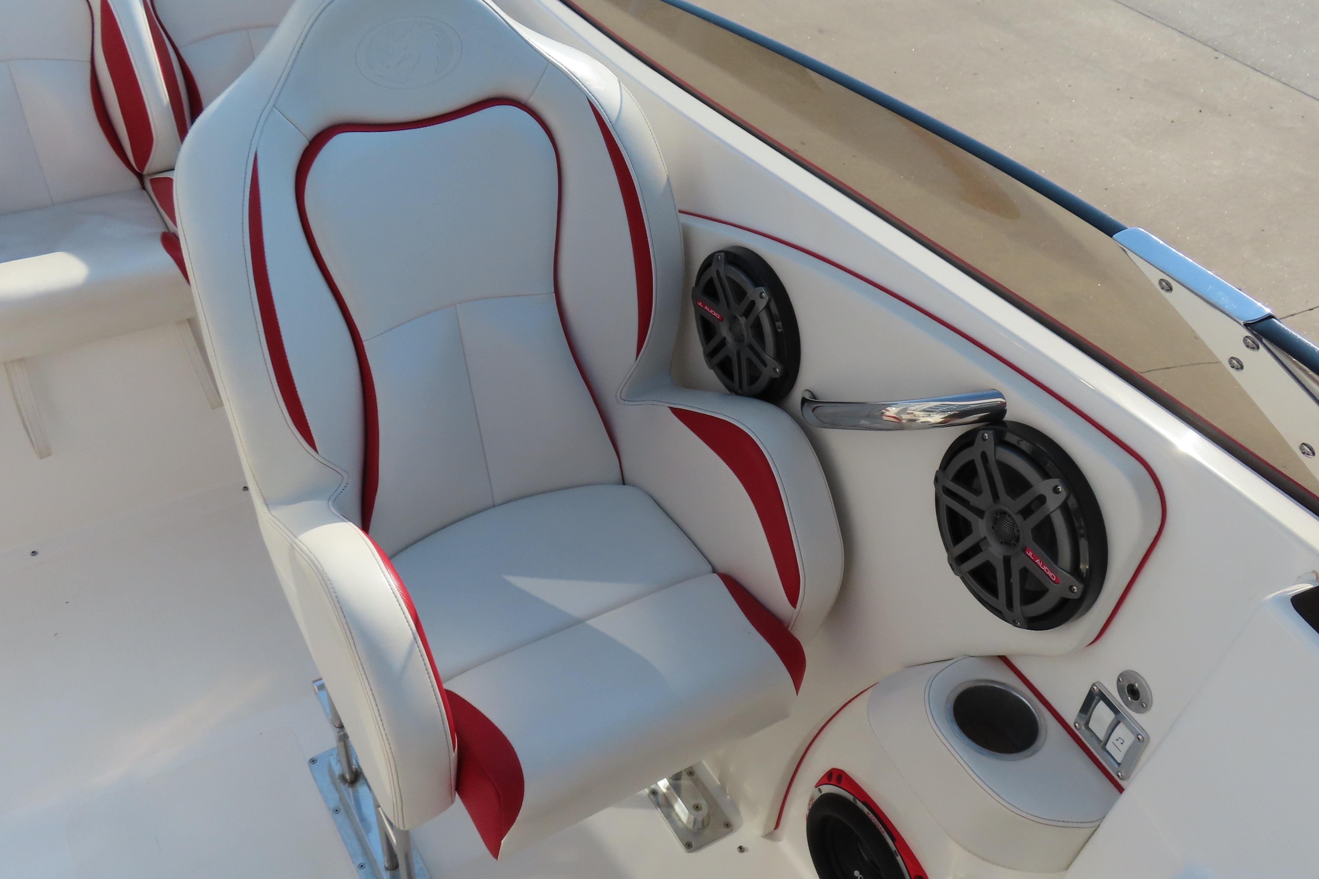Luxurious seating in 2013 Nordic 39 POKER RUN boat with red accents and built-in speakers.