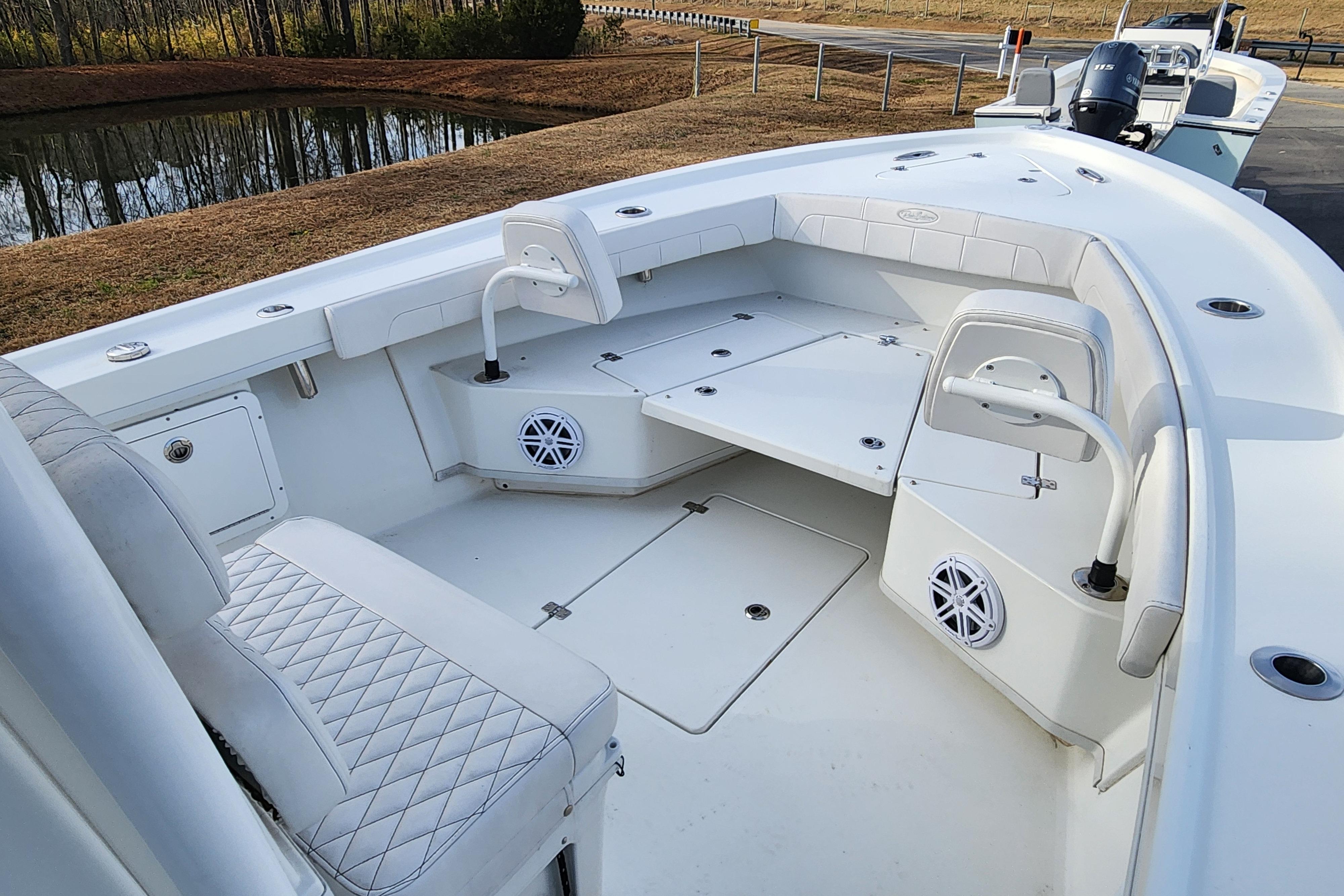 2024 Pair Customs 27 CC boat interior with cushioned seating and storage compartments.