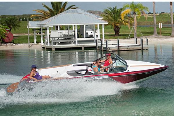 Manufacturer Provided Image: 2016 Nautique Ski Nautique 200 Closed Bow boat cruising on a lake near a dock and gazebo.