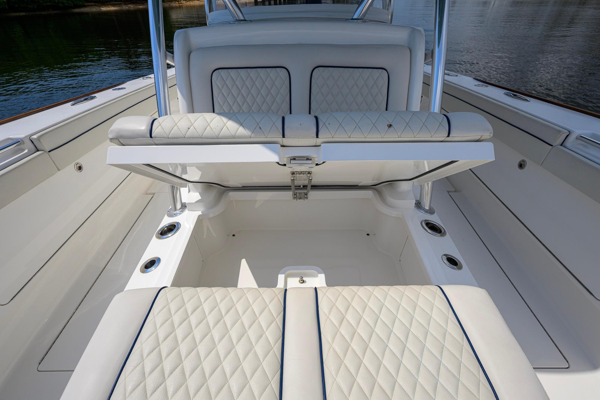 2020 Valhalla Boatworks V-41 interior with diamond-stitched seating and storage compartment.