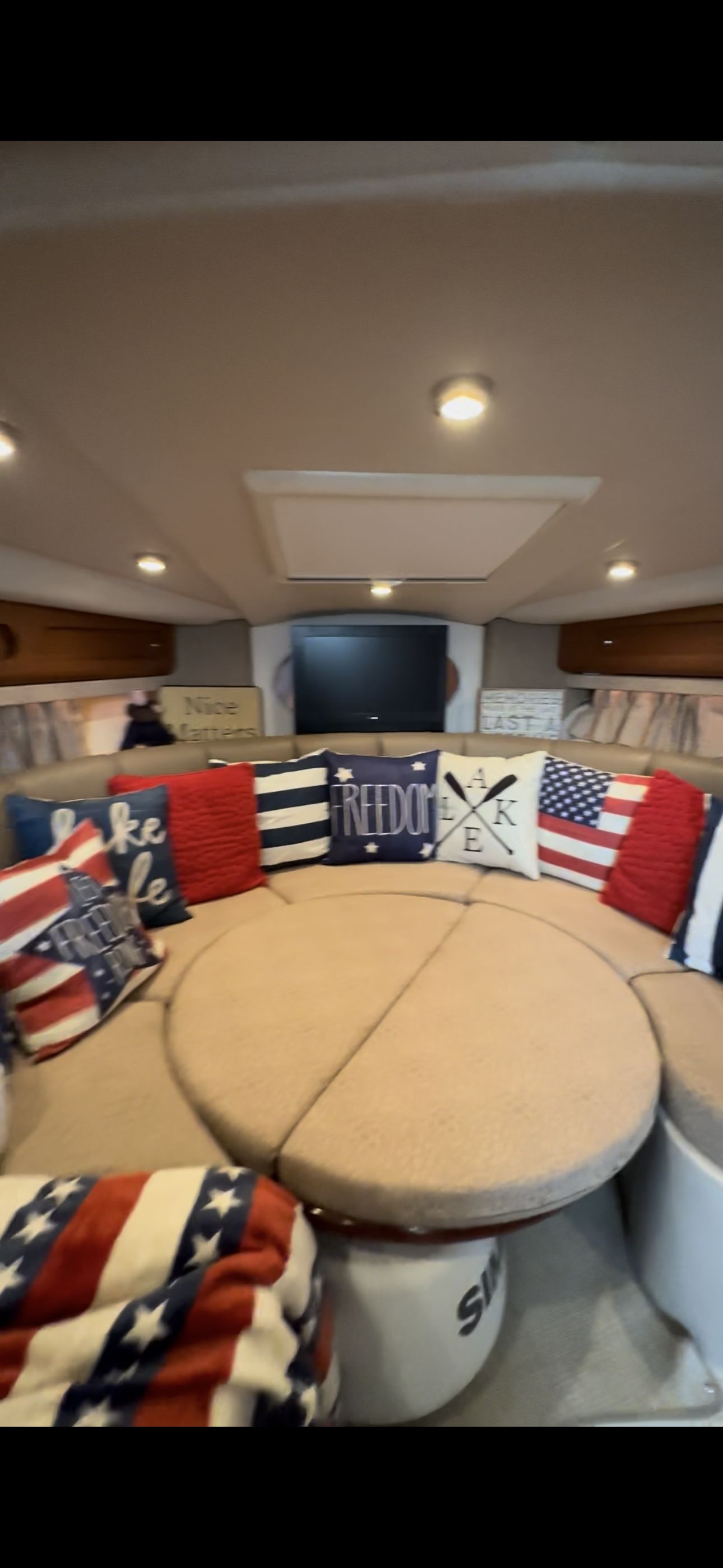 The interior of a 2004 Chaparral Signature 330 features a cozy seating area with decorative cushions.