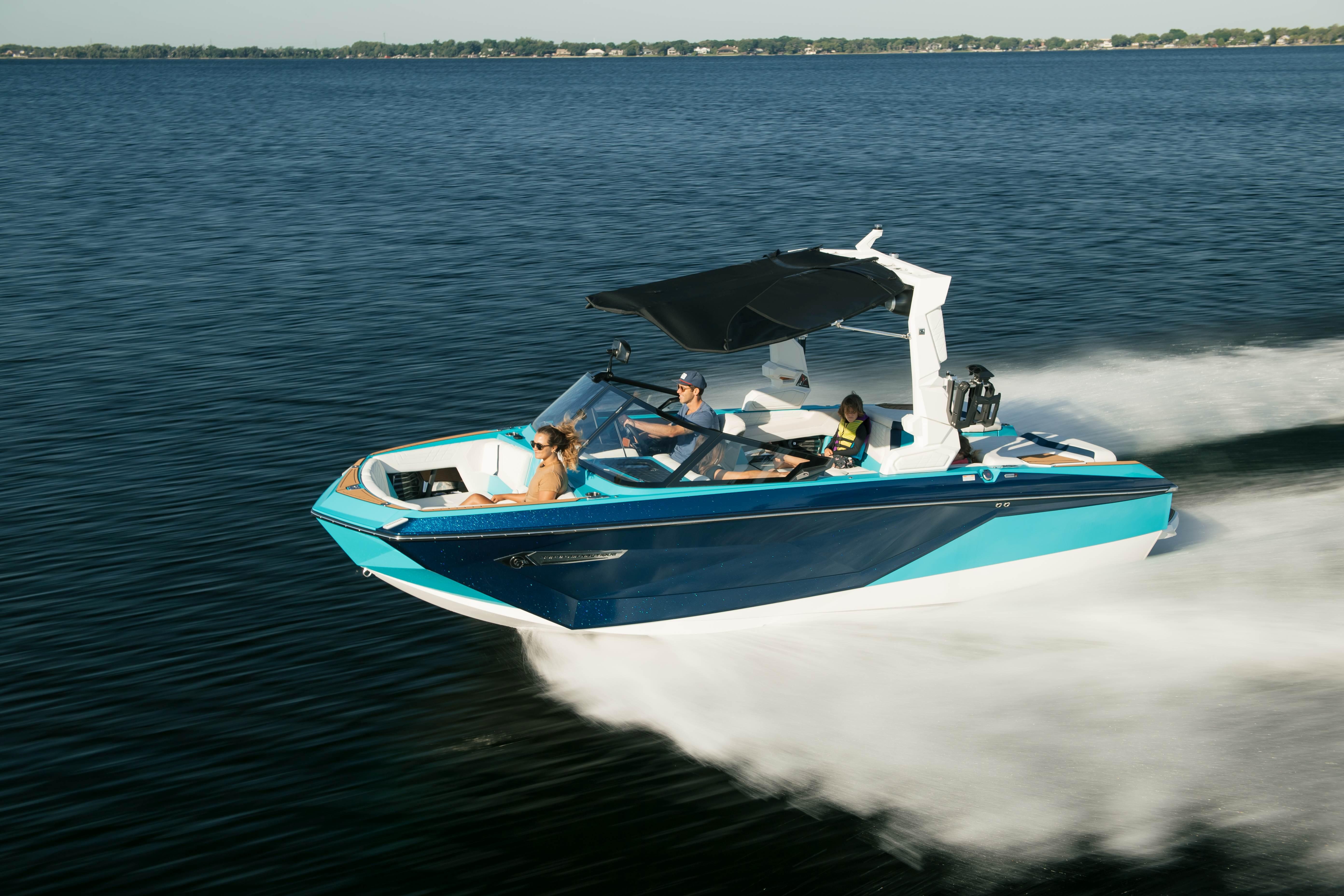 2026 Nautique G21 boat cruising on a lake with passengers enjoying the ride.