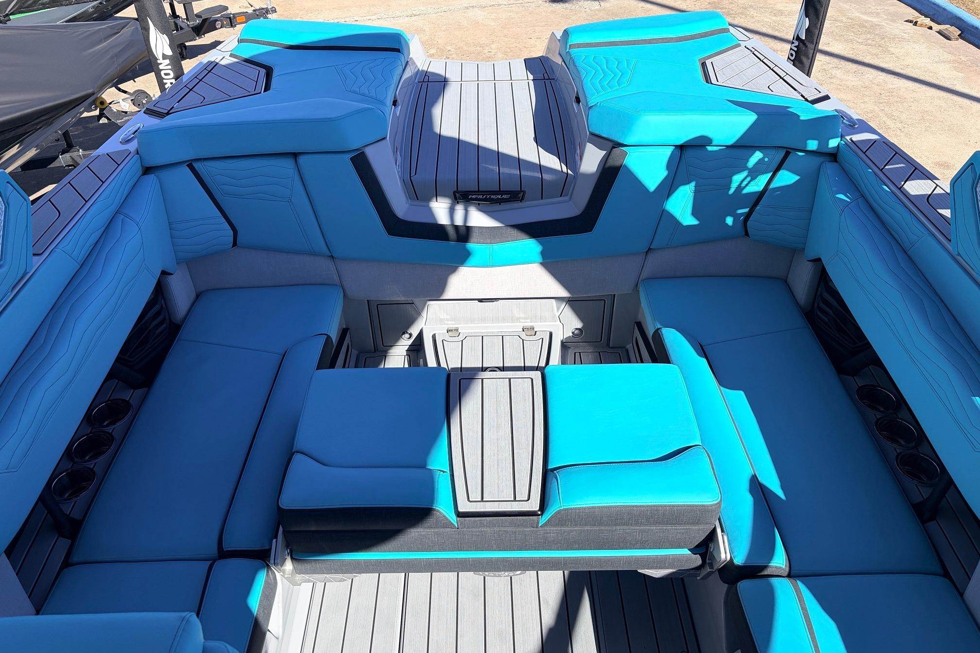 Interior of 2026 Nautique Super Air Nautique G23 with blue seating and modern design.