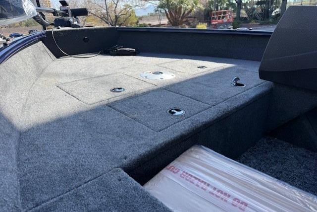 2026 Tracker Pro Guide V-16 SC boat interior with carpeted deck and storage compartments.