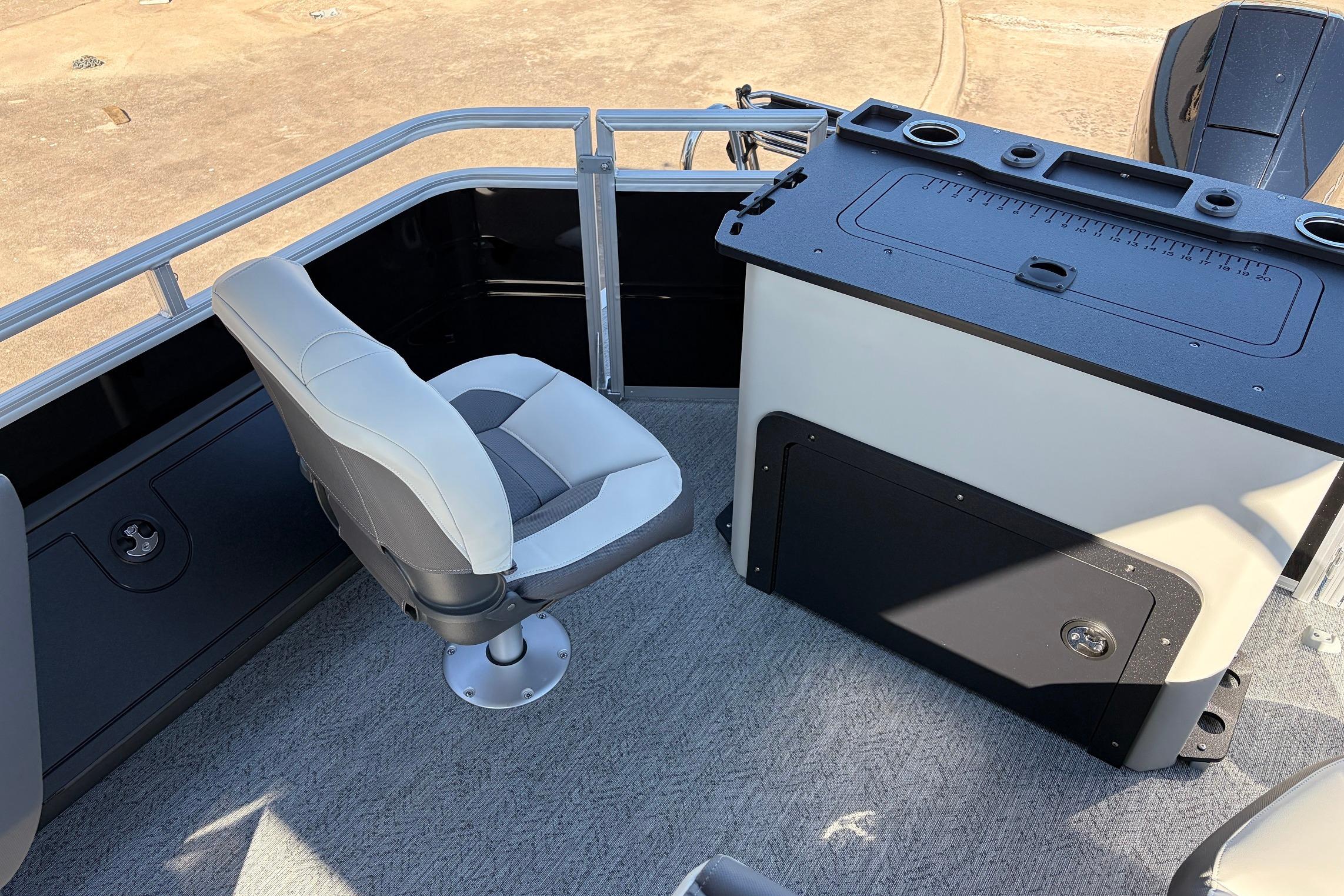2026 Sun Tracker Fishin' Barge 22 XP3 interior with swivel seat and fishing station.