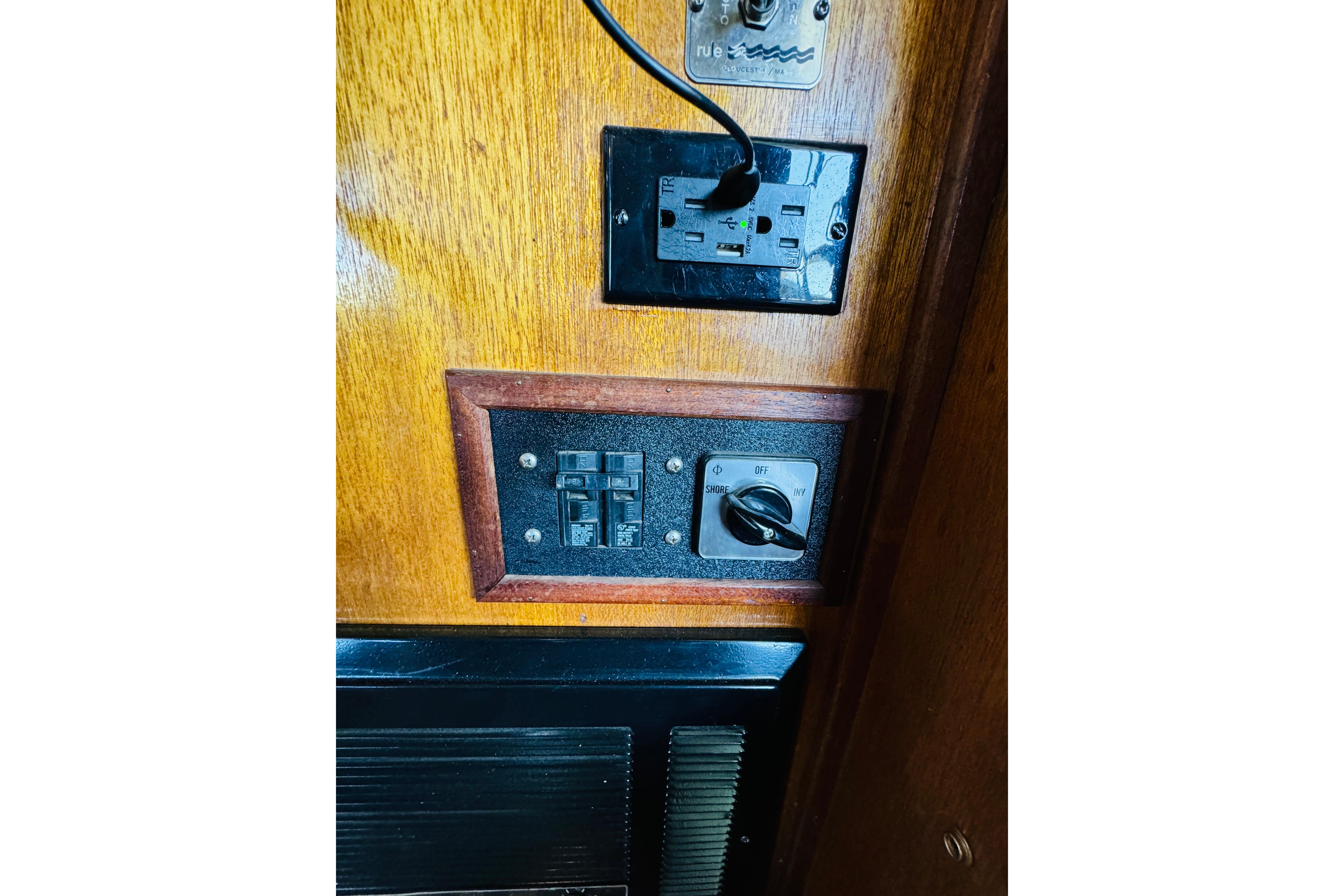 Electrical panel on a 1978 Californian 42 LRC boat, featuring switches and outlets.