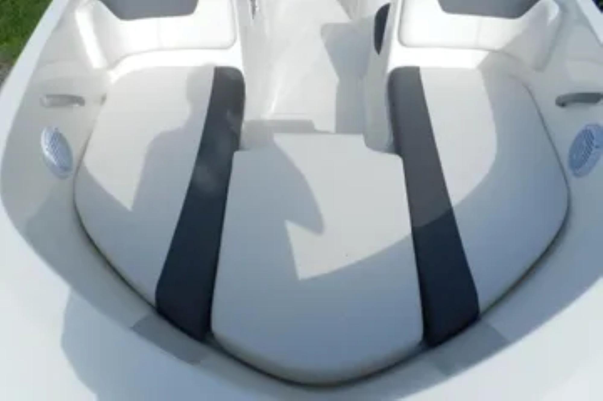 2026 Bayliner Element E18 boat interior seating, featuring white and gray cushioned seats.