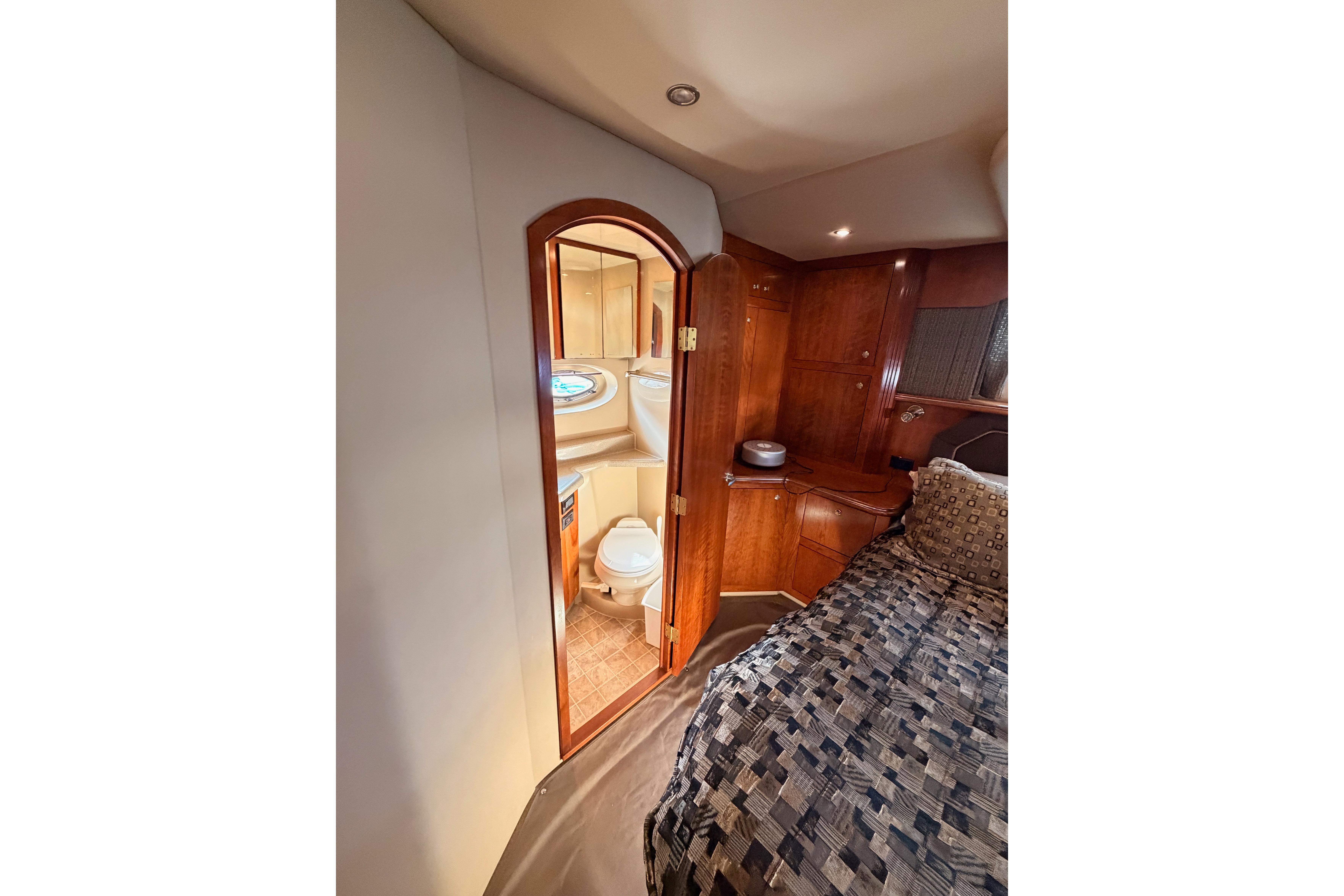 Luxurious 2005 Cruisers Yachts 405 Express Motoryacht interior with bedroom and bathroom view.