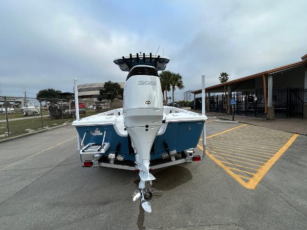 2024 Sea Pro 250 DLX boat, rear view, parked on a trailer in a lot.