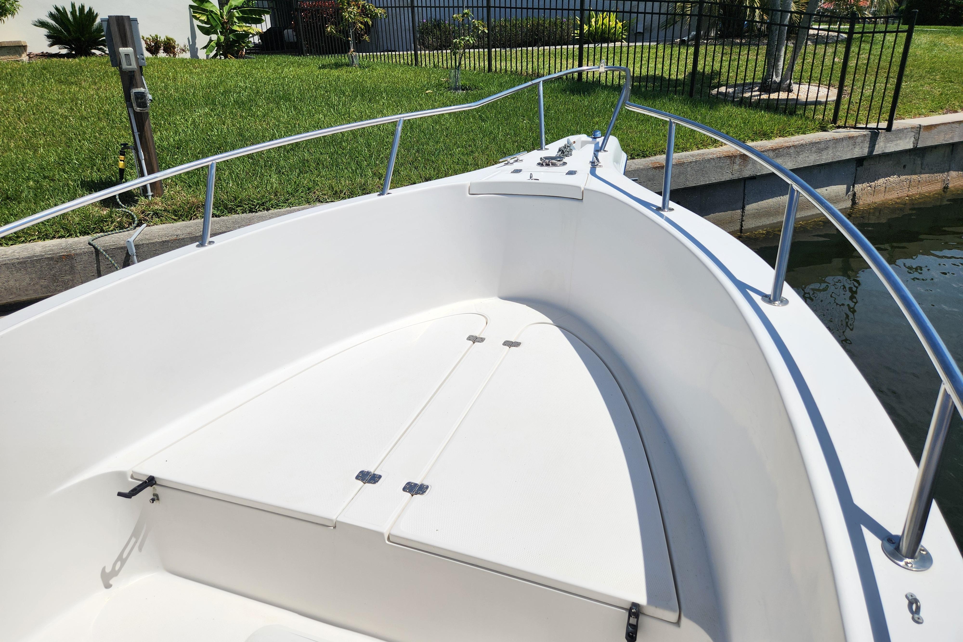 2001 Cobia 234 Center Console boat bow with white deck and railing.