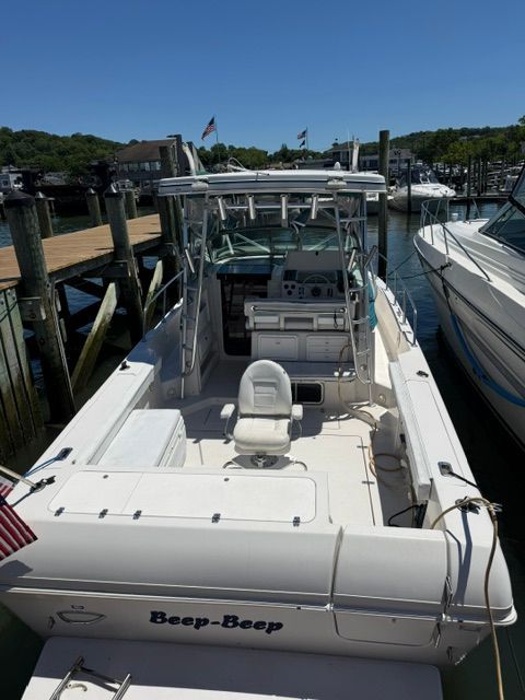 A 1995 Pro-Line 2950 Walkaround boat docked, featuring a helm and seating area.