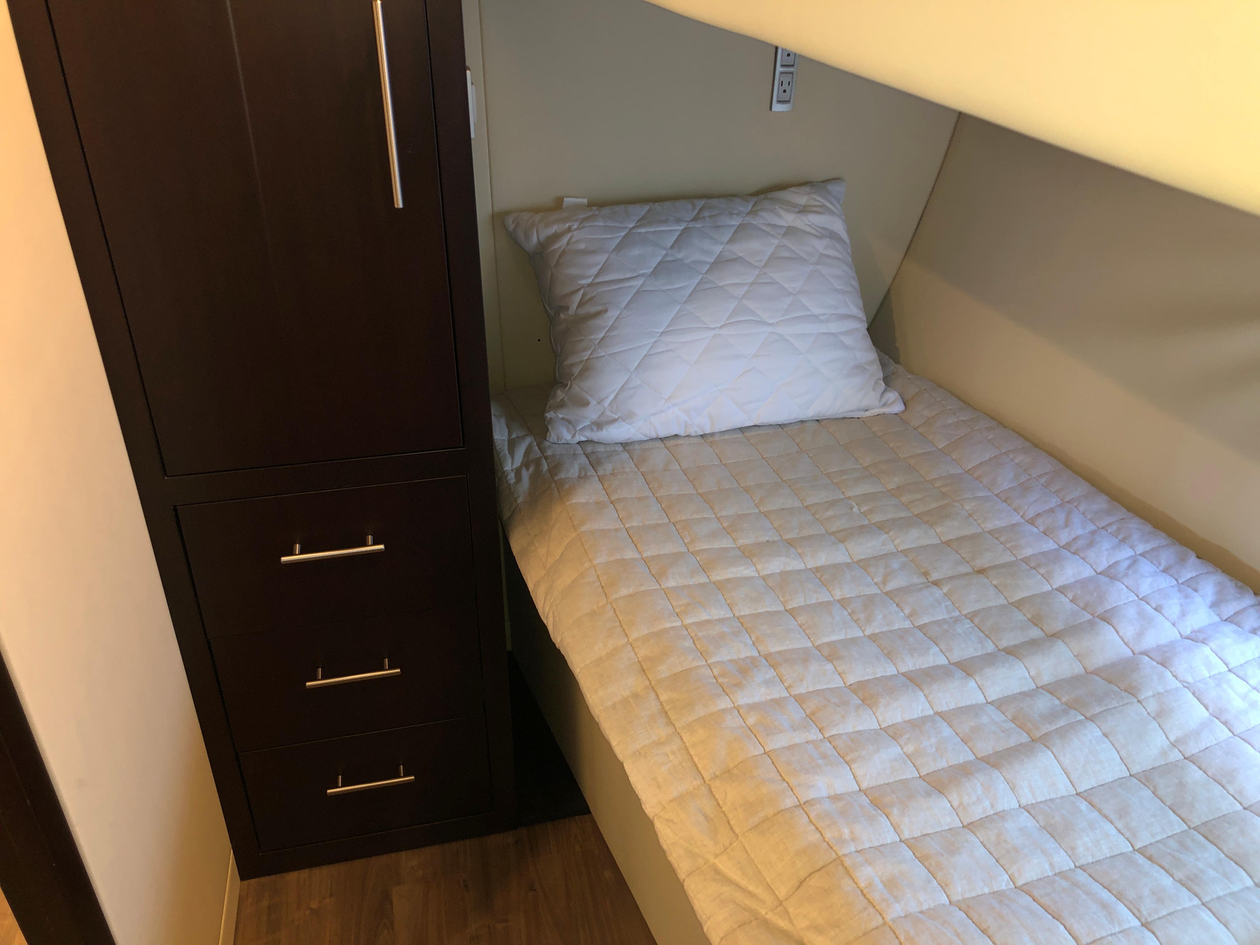 Cozy cabin bed with quilted bedding in 2017 Regal 53 Sport Coupe yacht.