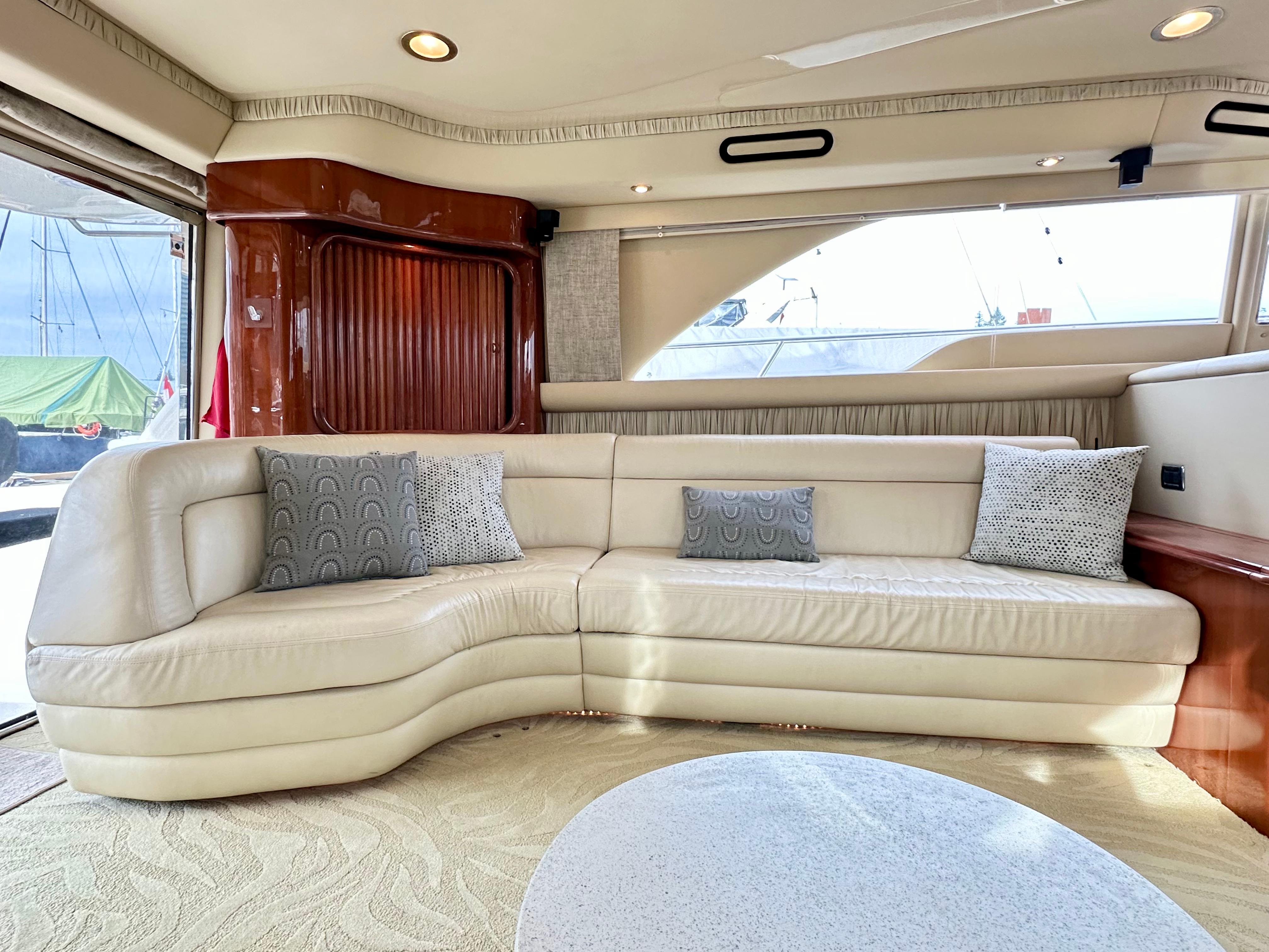 Luxurious interior of 2002 Sea Ray 560 Sedan Bridge yacht with cream leather seating.