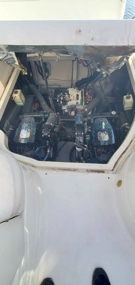 Engine compartment of a 2002 Wellcraft 3300 Martinique with dual engines and technical components.