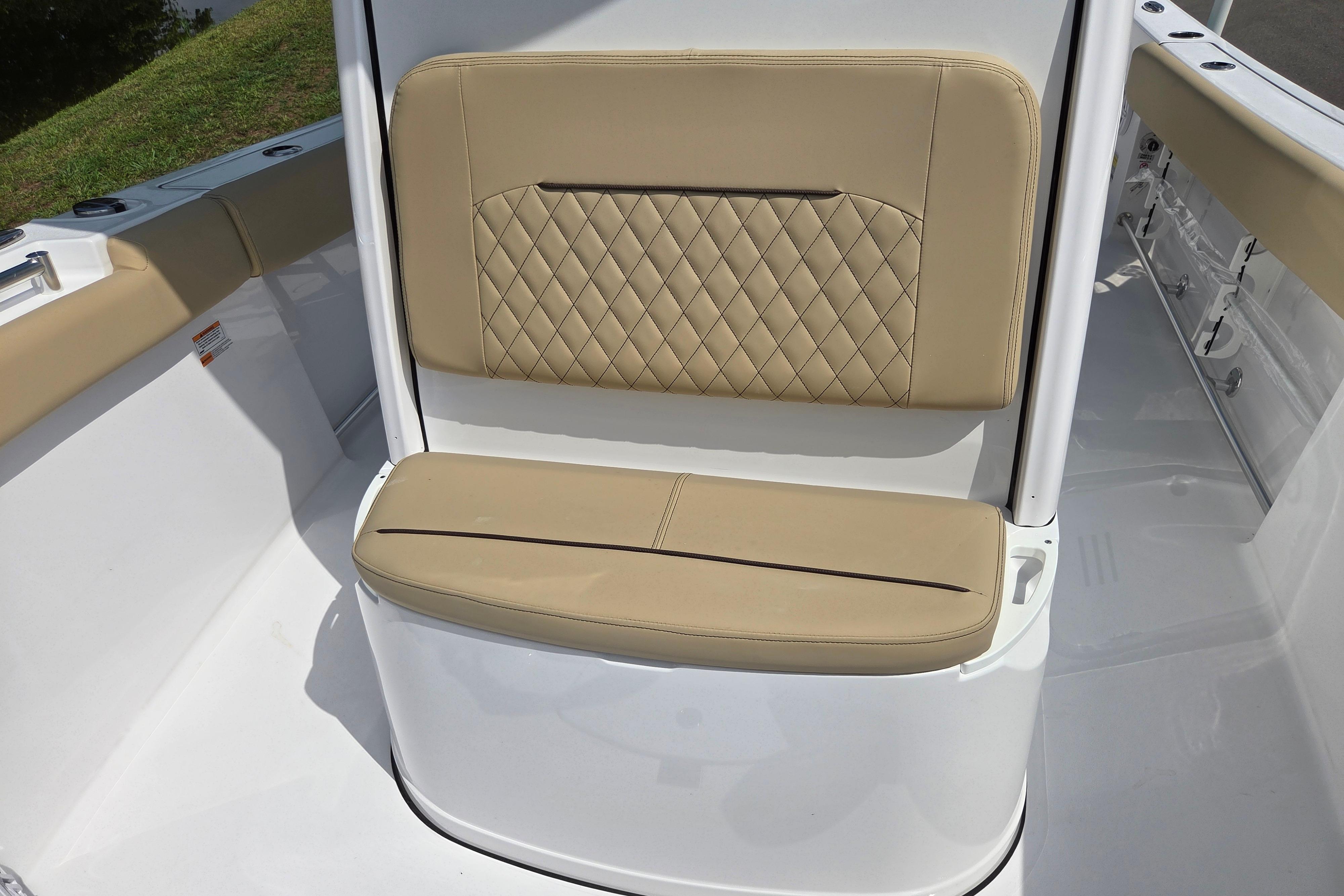 2026 Sportsman Open 232 Center Console boat with tan cushioned seating.