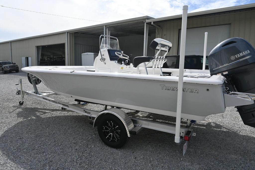 2026 Tidewater 1910 Bay Max boat on trailer, parked outside a warehouse.