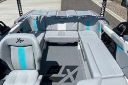 2025 MasterCraft XT22 boat interior with gray and blue seating, showcasing modern design.