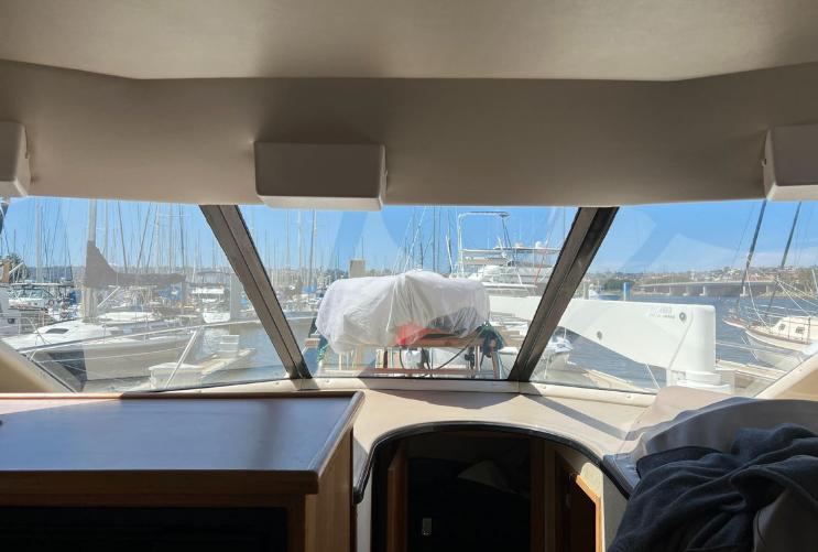 Interior view from a 1997 Bayliner 3788 Command Bridge Motoryacht, overlooking a marina.