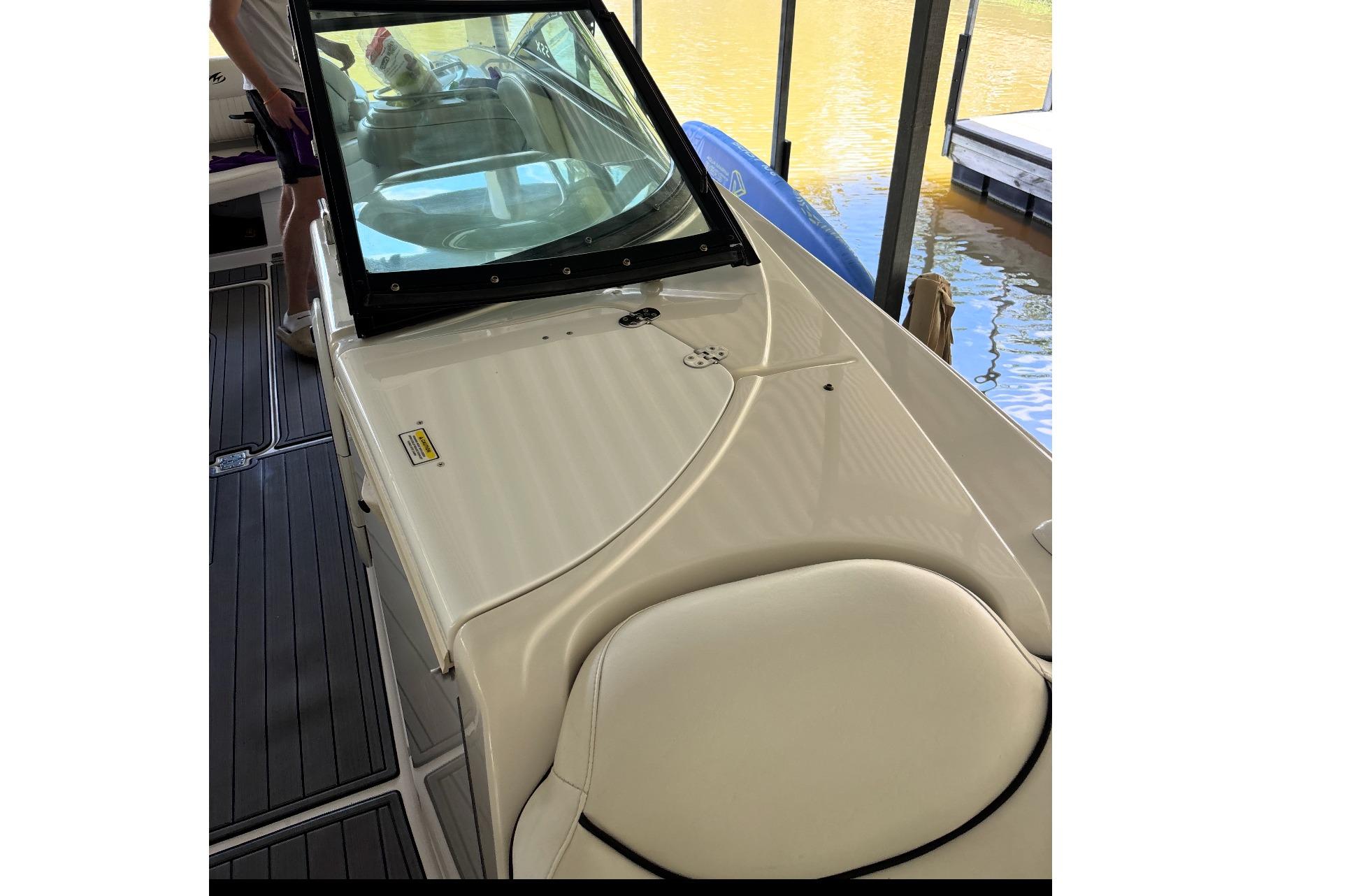 2007 Monterey 298SSX Super Sport boat interior with seating and windshield, docked by water.