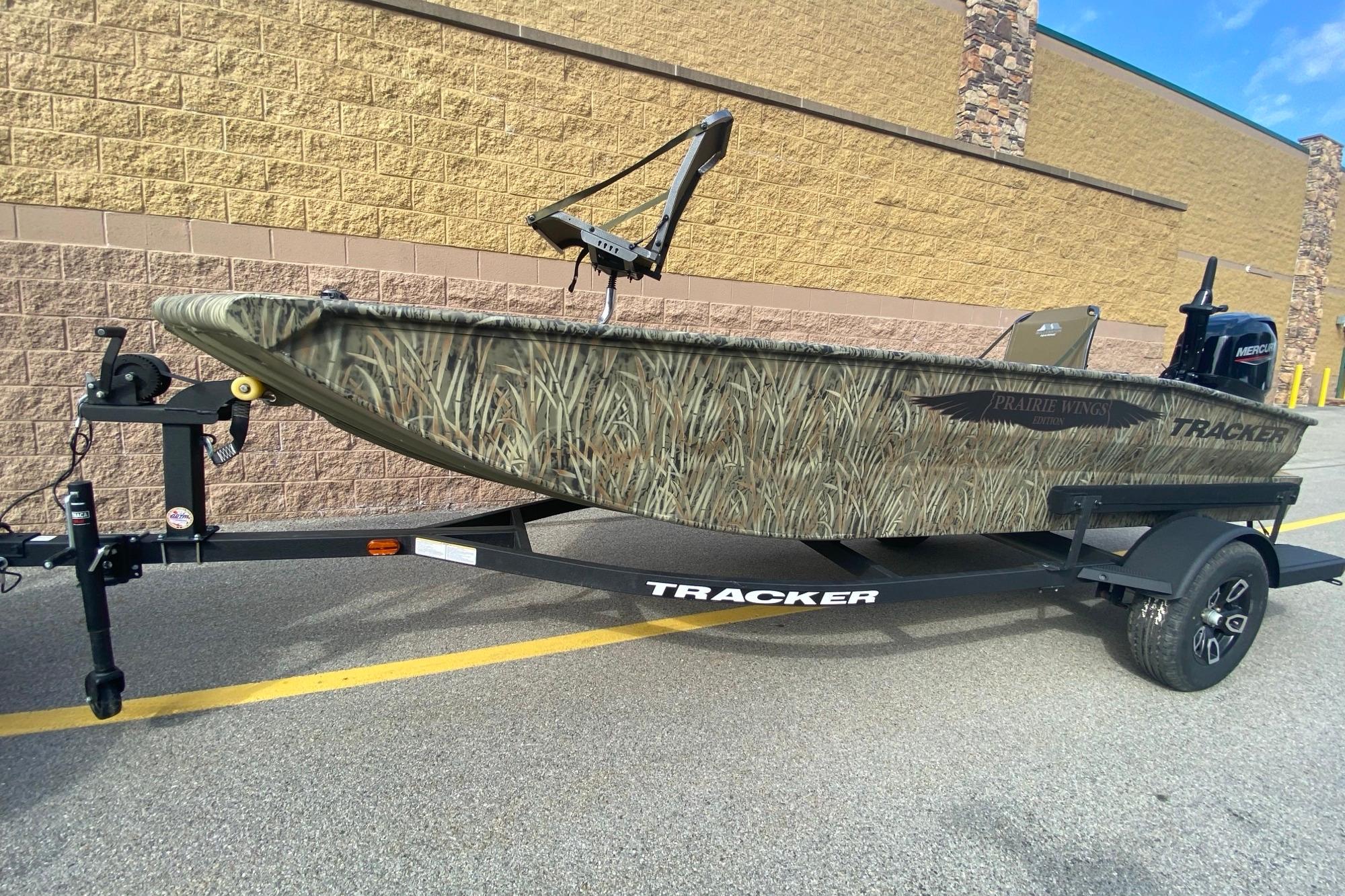 2026 Tracker Grizzly 1650 T Prairie Wings Edition boat on trailer, camouflage design.