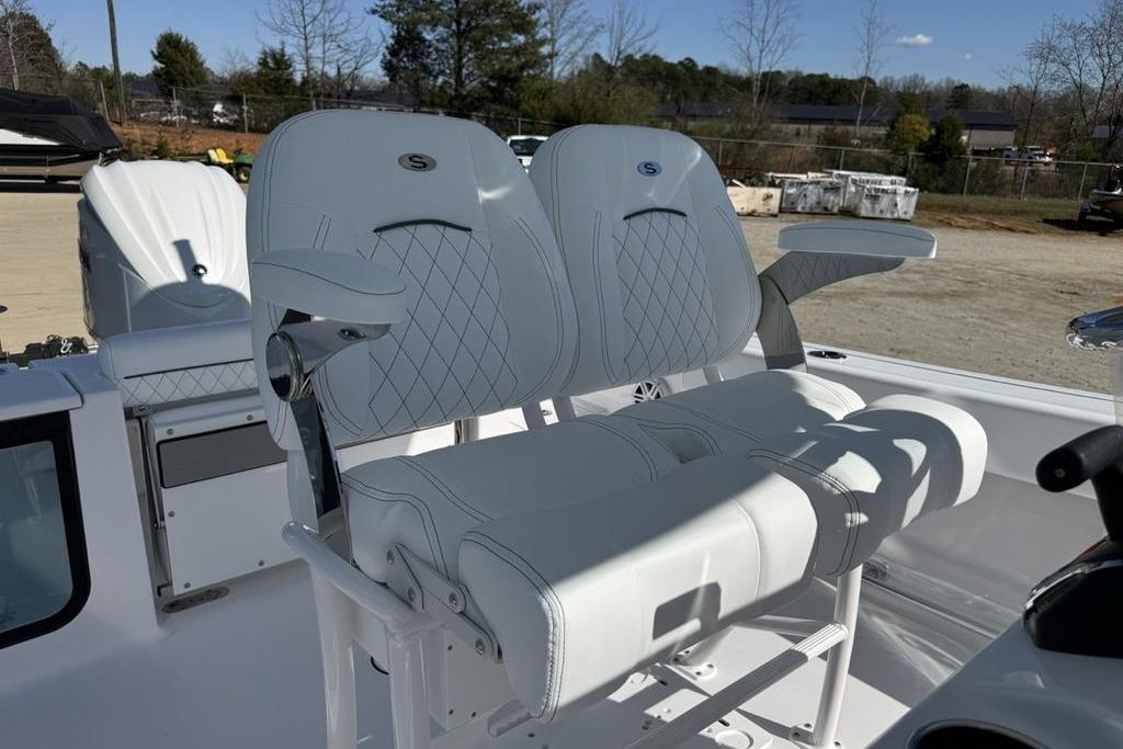 2026 Sportsman Open 232 Center Console boat with white cushioned seating.