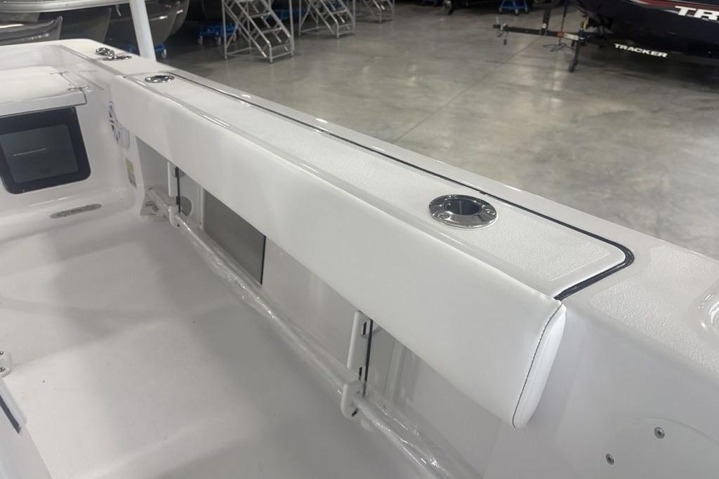 2026 Sportsman Masters 227 boat interior with white seating and rod holders.