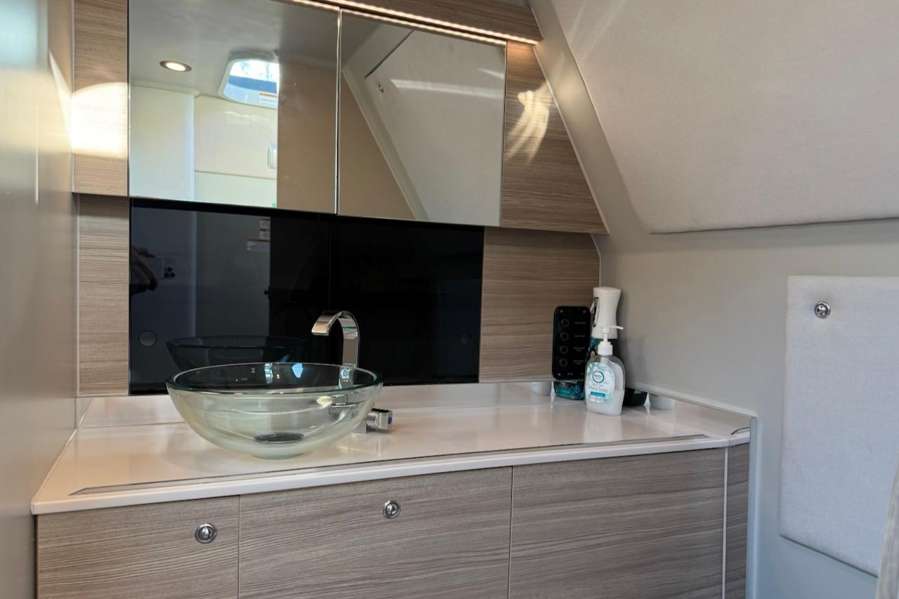 Modern bathroom interior of 2024 Saxdor 320 GTC yacht with glass sink and sleek cabinetry.