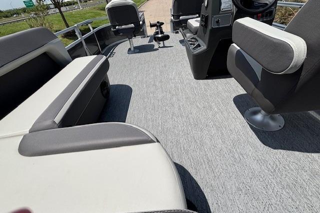 2026 Sun Tracker Bass Buggy 16 XL Select interior with gray seating and steering console.