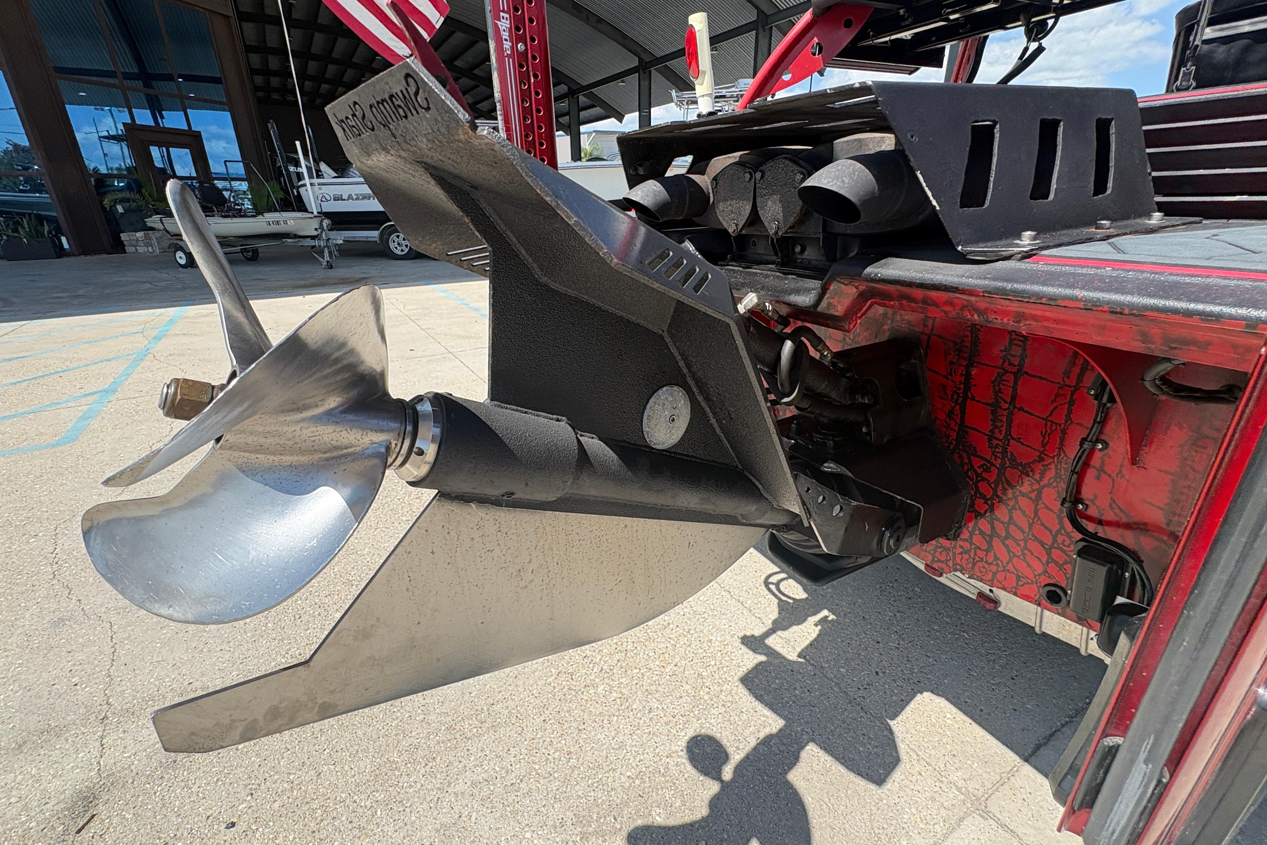 Close-up of a 2018 Custom Swamp Shark 24' boat propeller and engine detail.