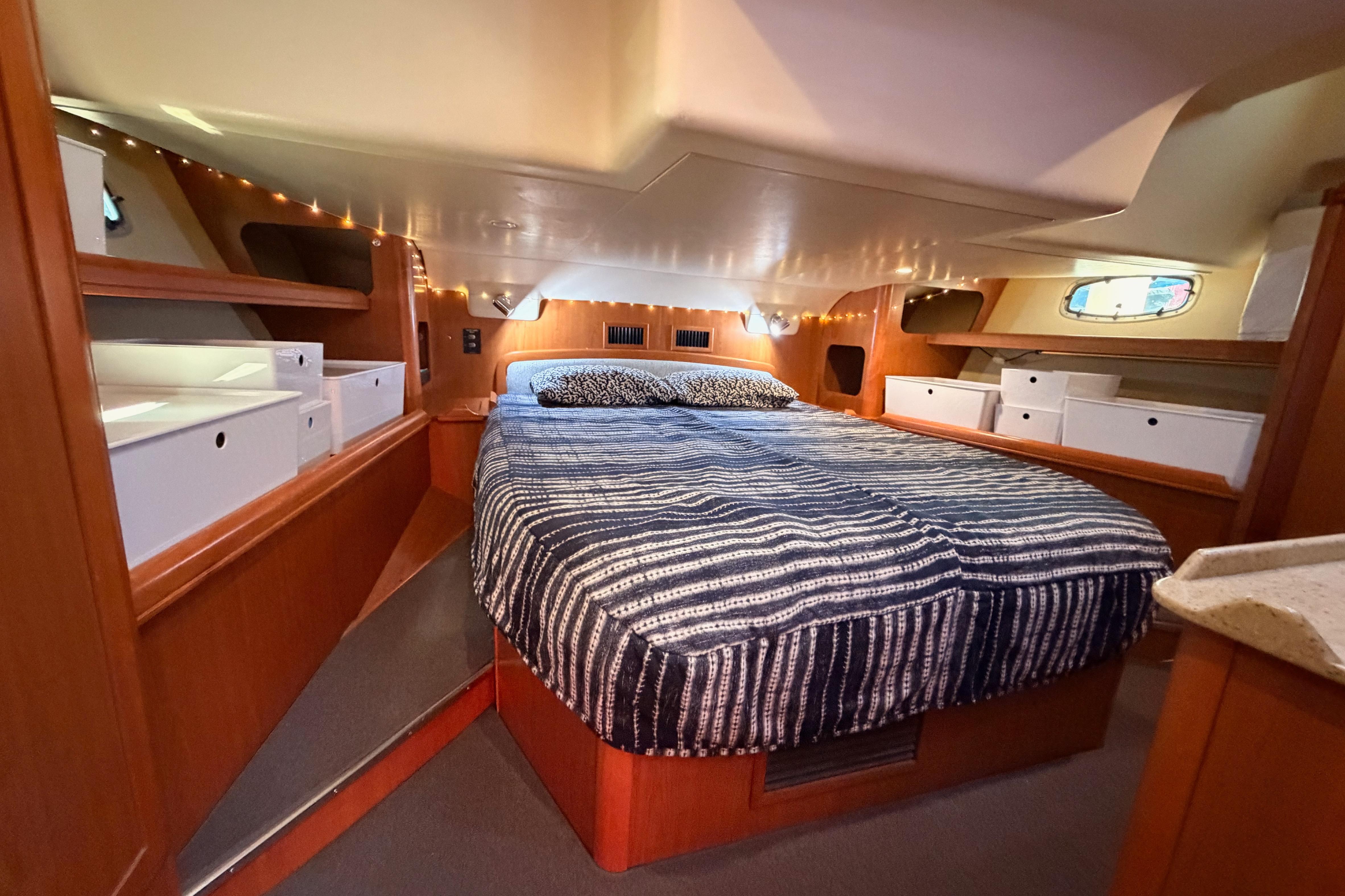 Luxurious interior of 2008 Hunter 45 Deck Salon with cozy bed and ample storage.