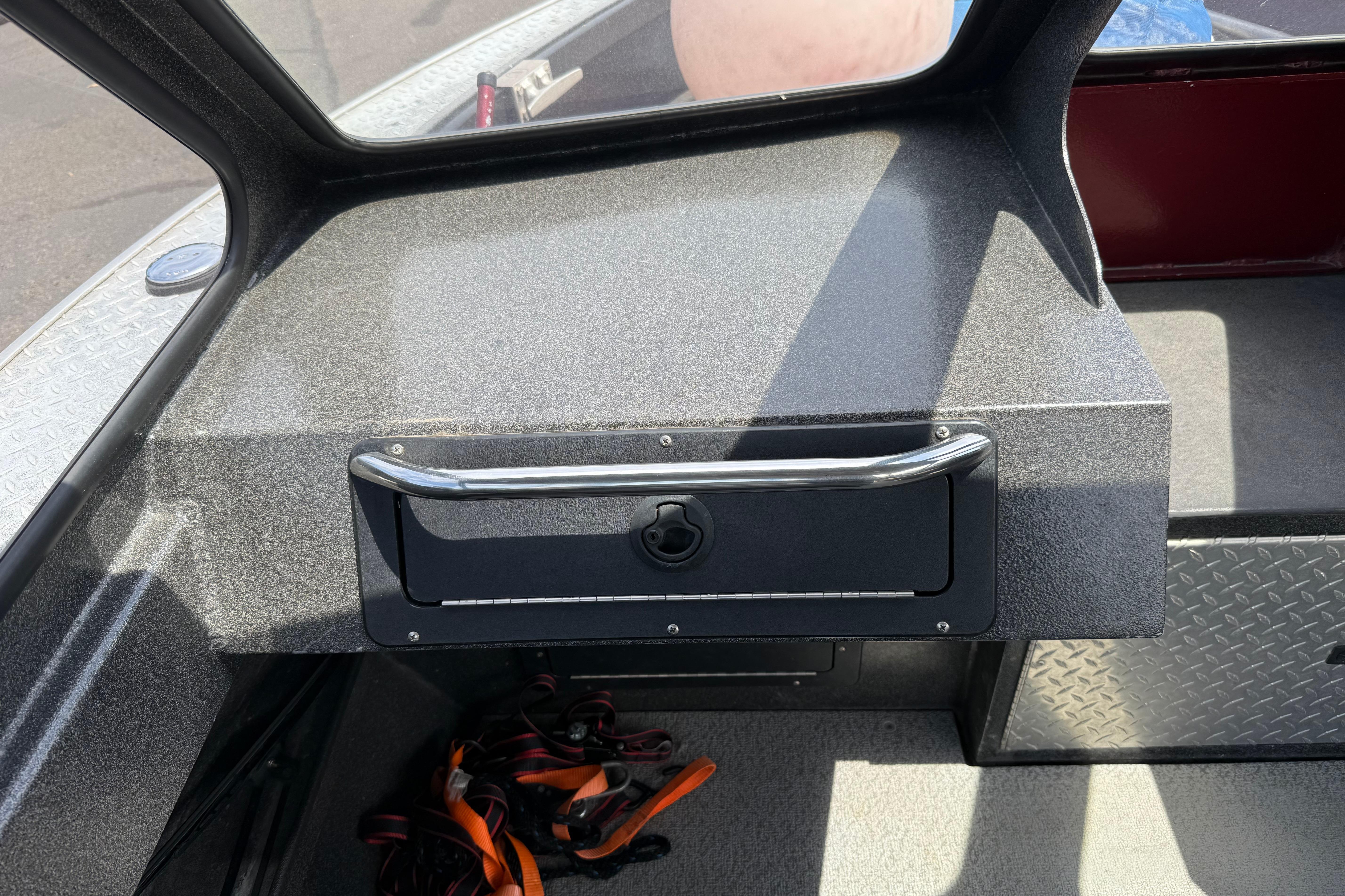 Interior of a 2005 Willie Raptor 21' boat showing dashboard and storage compartment.